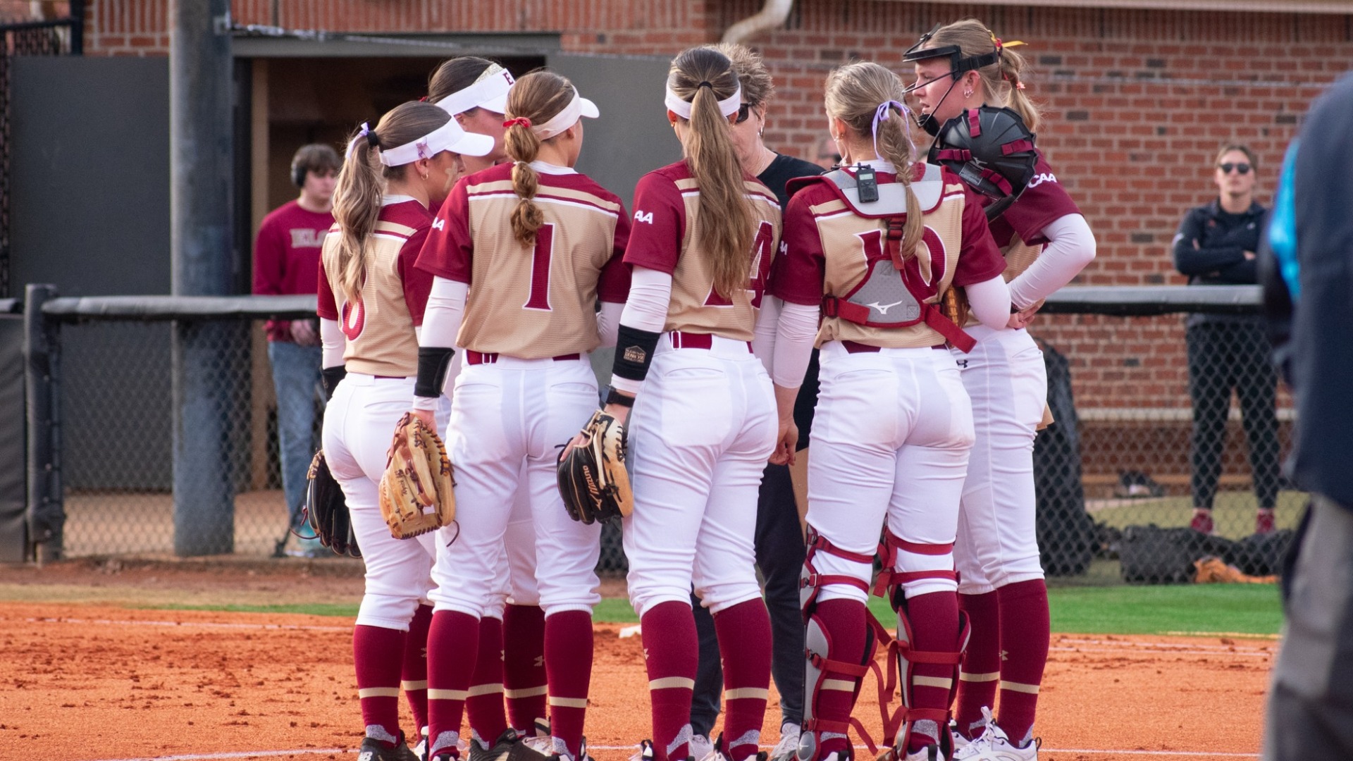 Elon Softball huddle versus Duke on Feb. 17