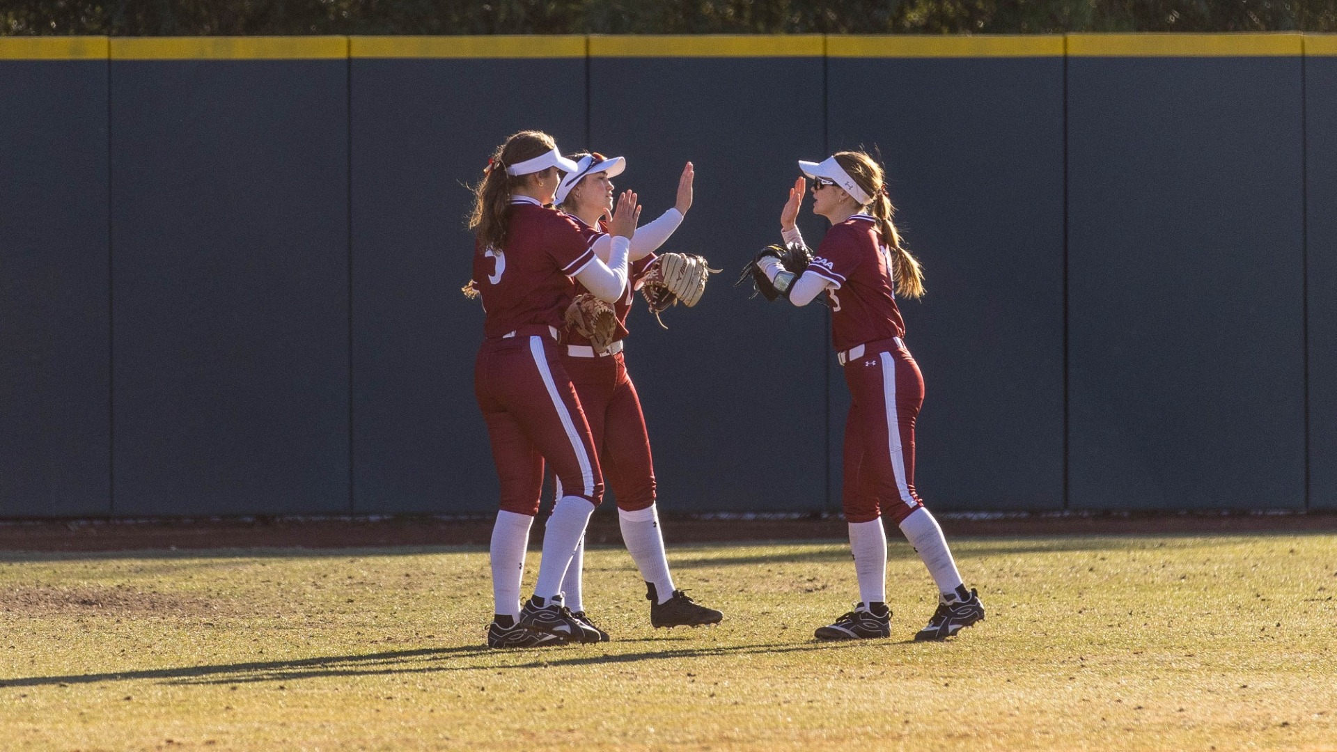 Elon outfielders versus Manhattan