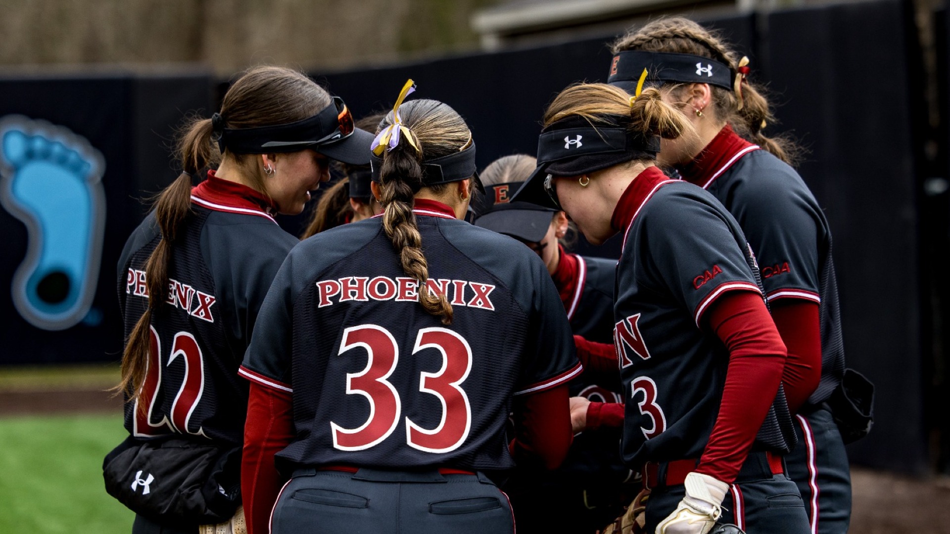 Elon softball huddle versus James Madison