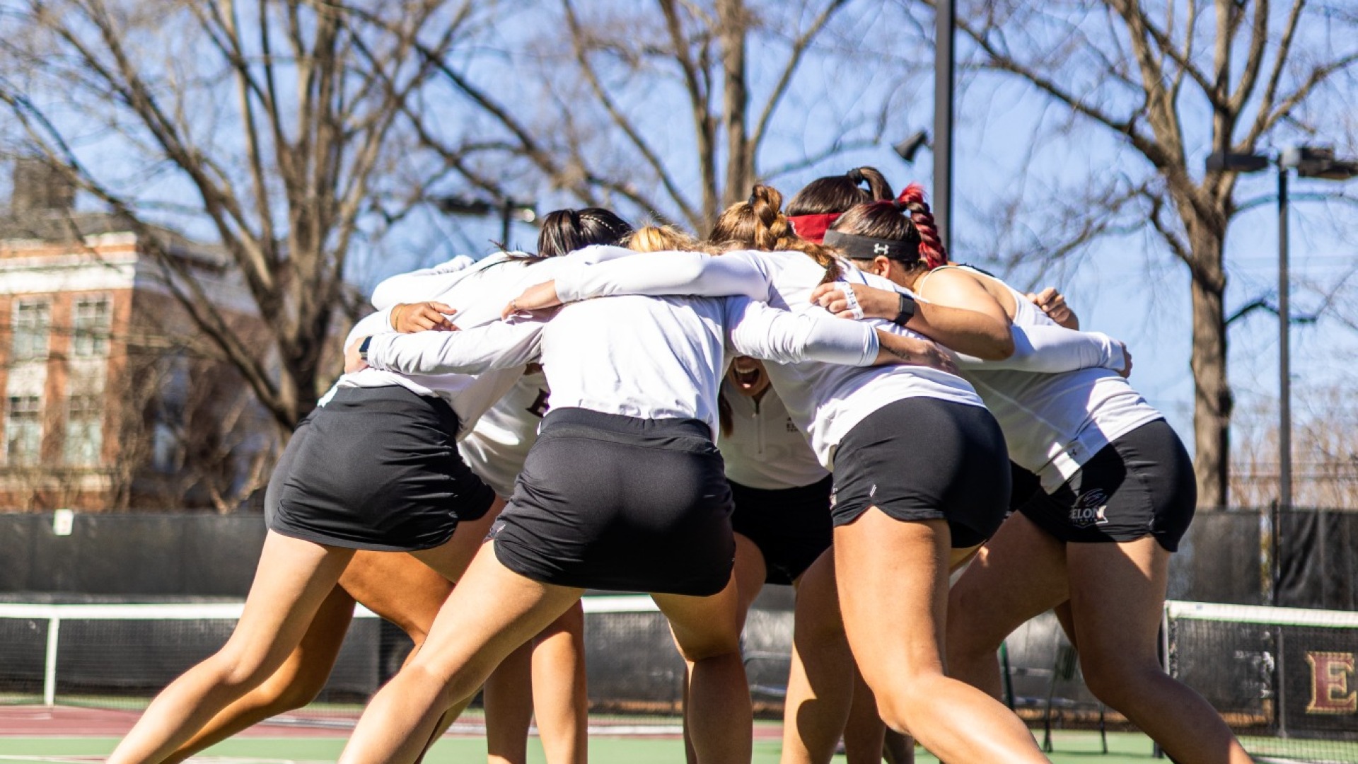 Women's Tennis huddle vs. Liberty
