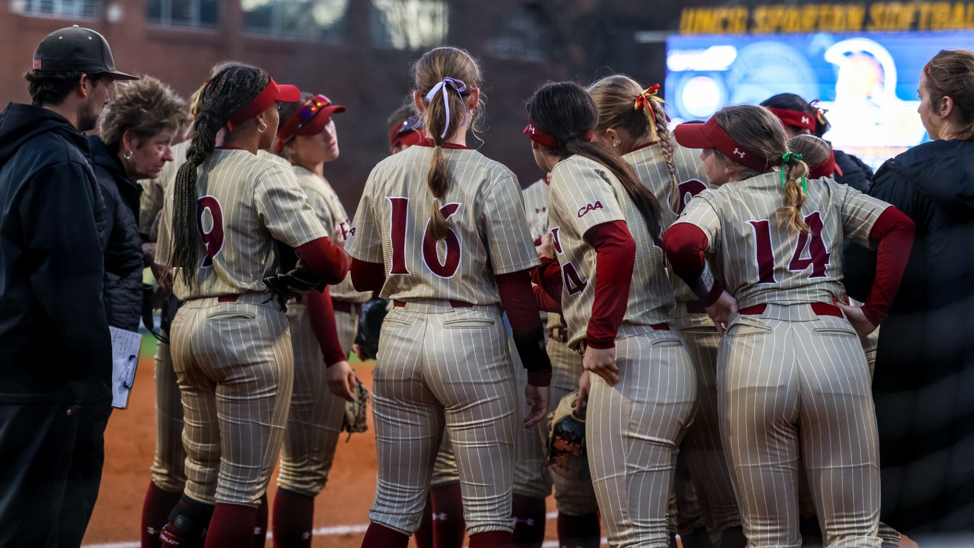 Elon softball huddle versus UNCG on Feb. 28