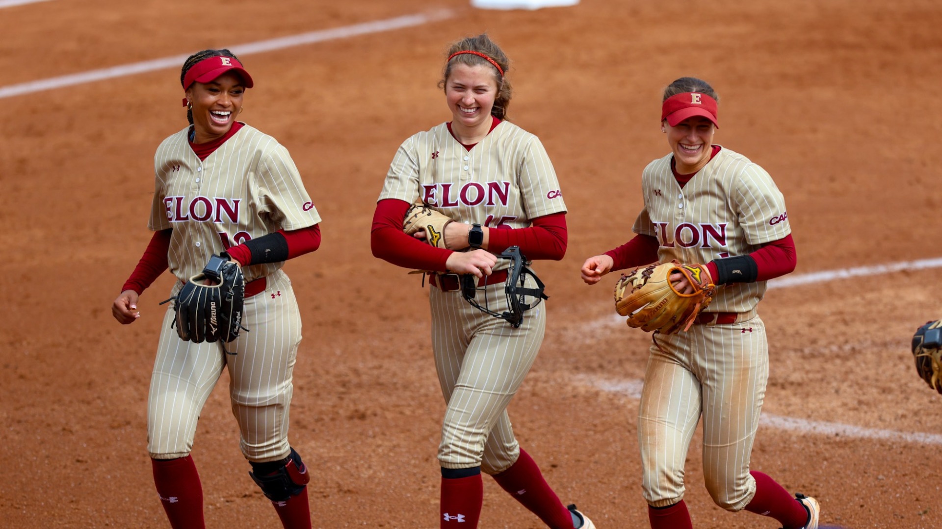 Anna Dew along with teammates Mauri Murray and Lani Wyrick versus Charleston Southern on Feb. 28