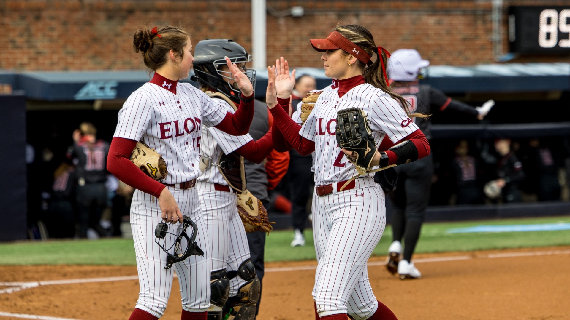 Anna Dew and Peyton Fitzpatrick of Elon softball celebrate versus Saint Joseph's