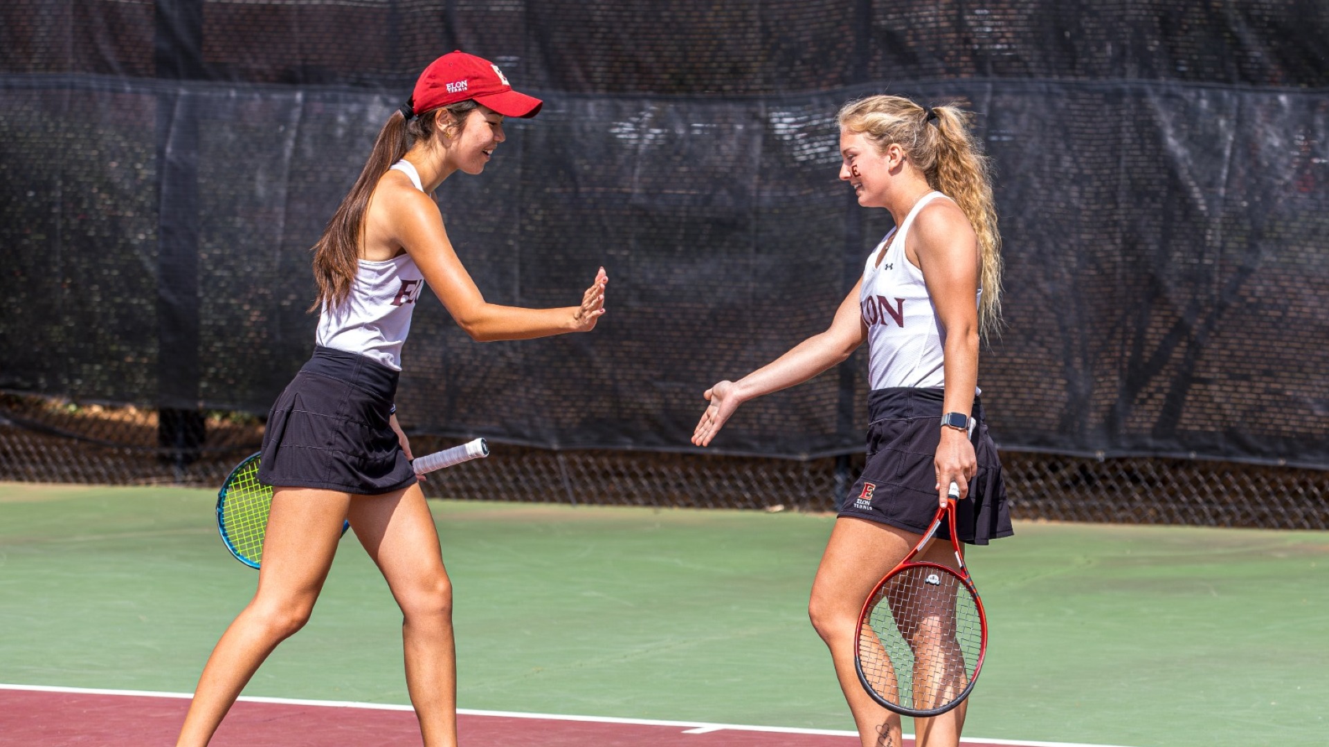 Madison Cordisco and Alexis Nyborg doubles high five vs. Queens