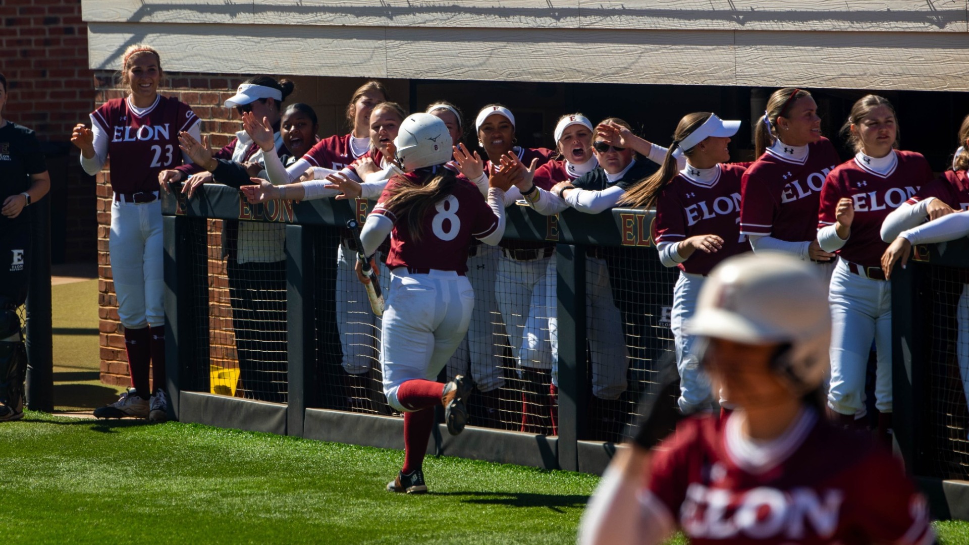 Greta Hessenthaler celebrates in front of the dugout versus Wofford on March 24