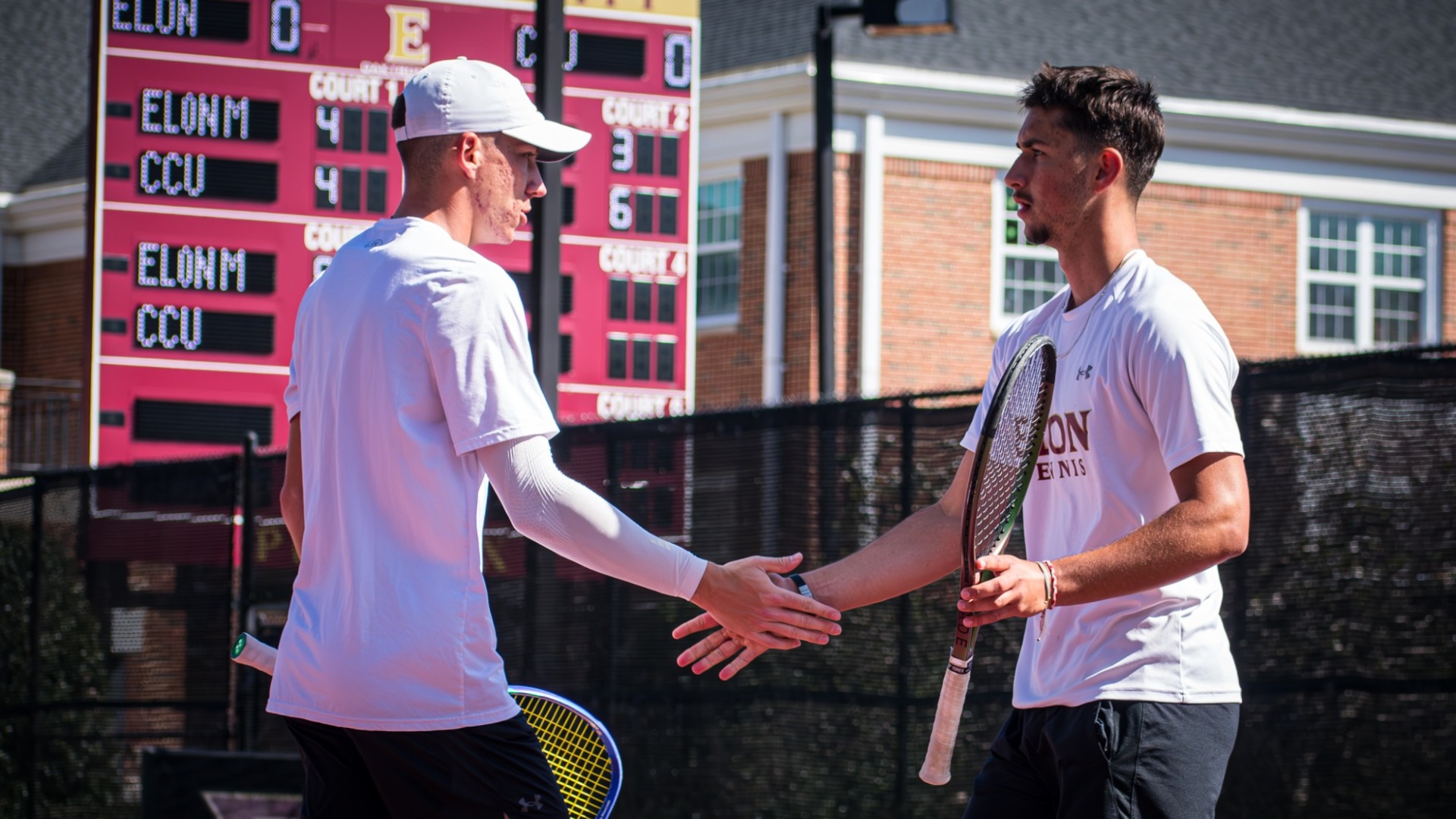 Veljko Krstic and Nikola Parichkov high five vs. Coastal Carolina