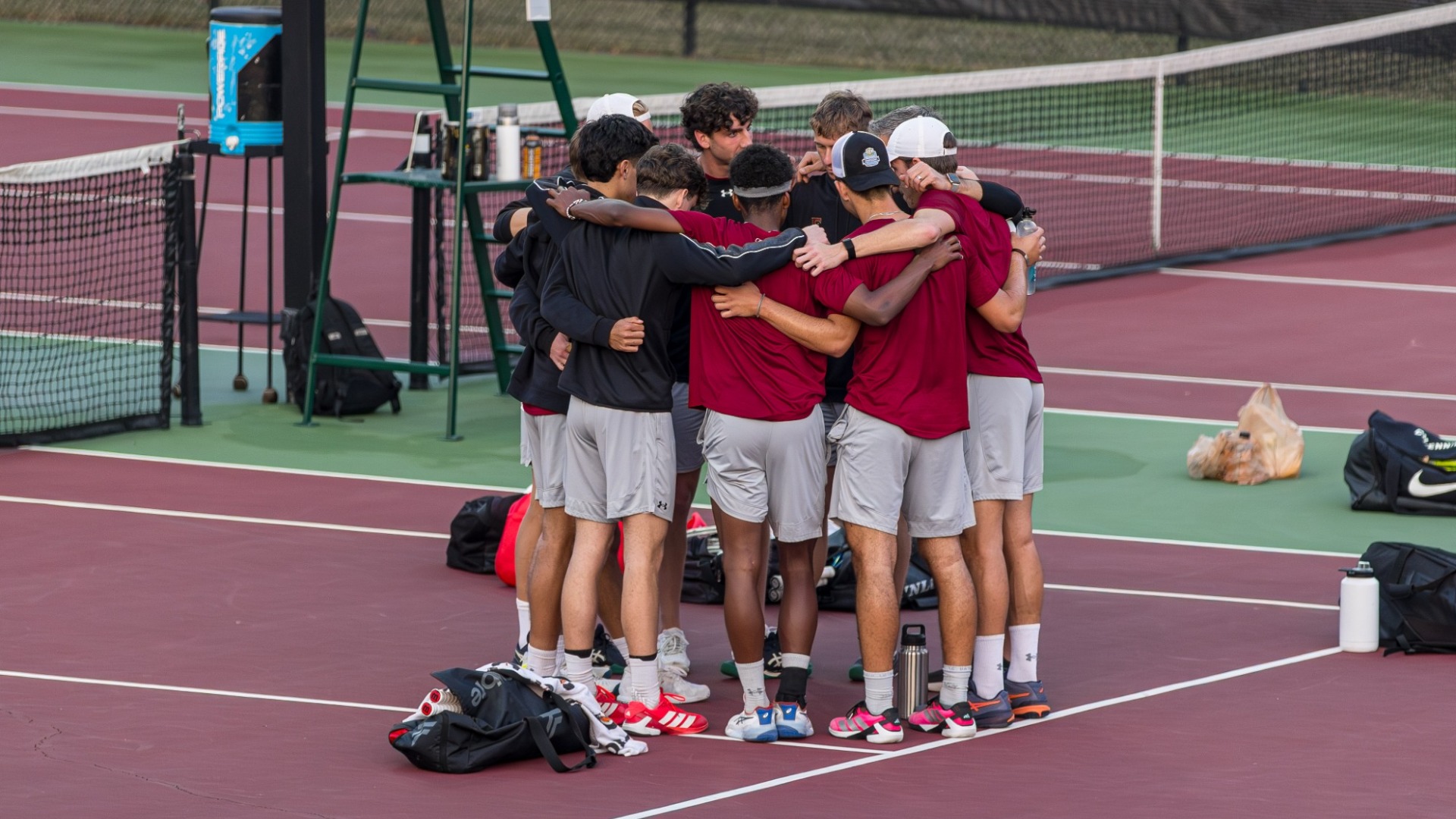 Men's Tennis huddle vs. Charlotte