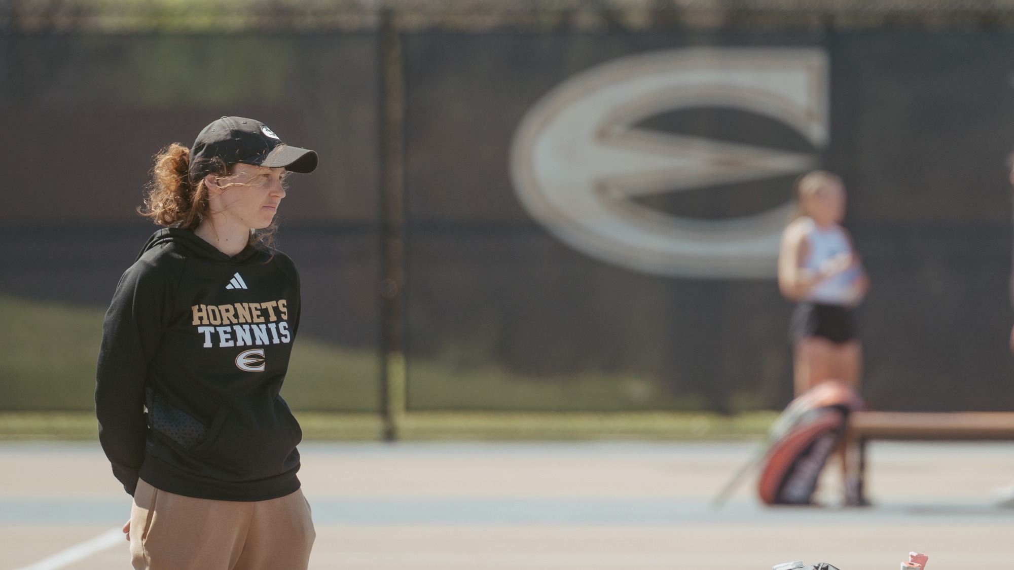 Emporia State Tennis Coach Cyrielle Peyroche coaching at Kossover Center