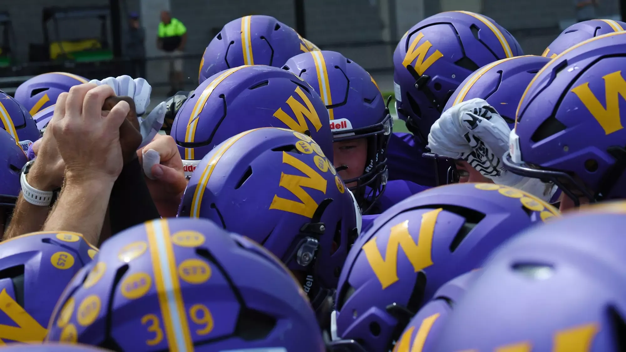 Williams helmets while huddling