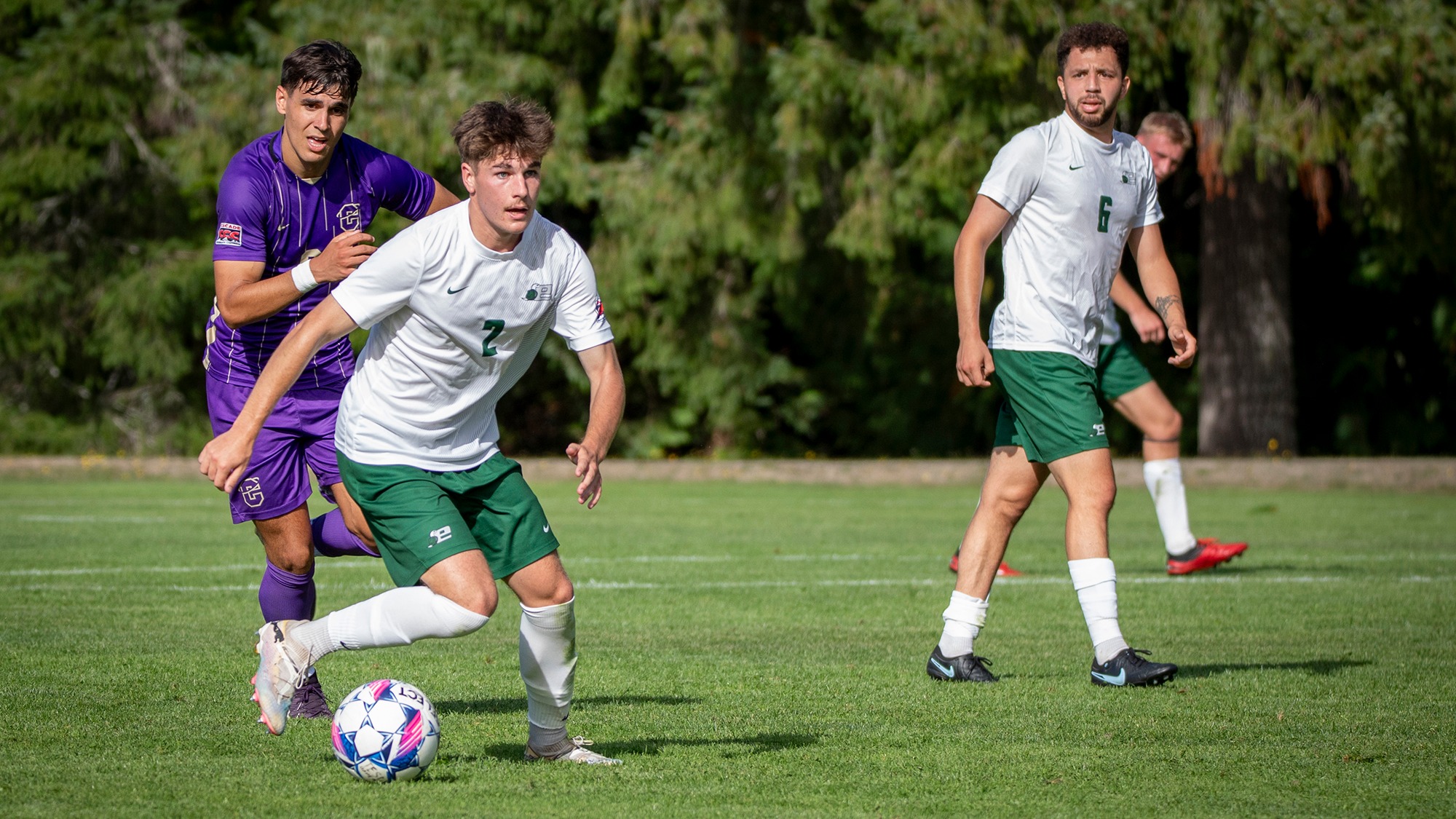 Walt Nichols looks upfield for options to pass while controlling the ball.