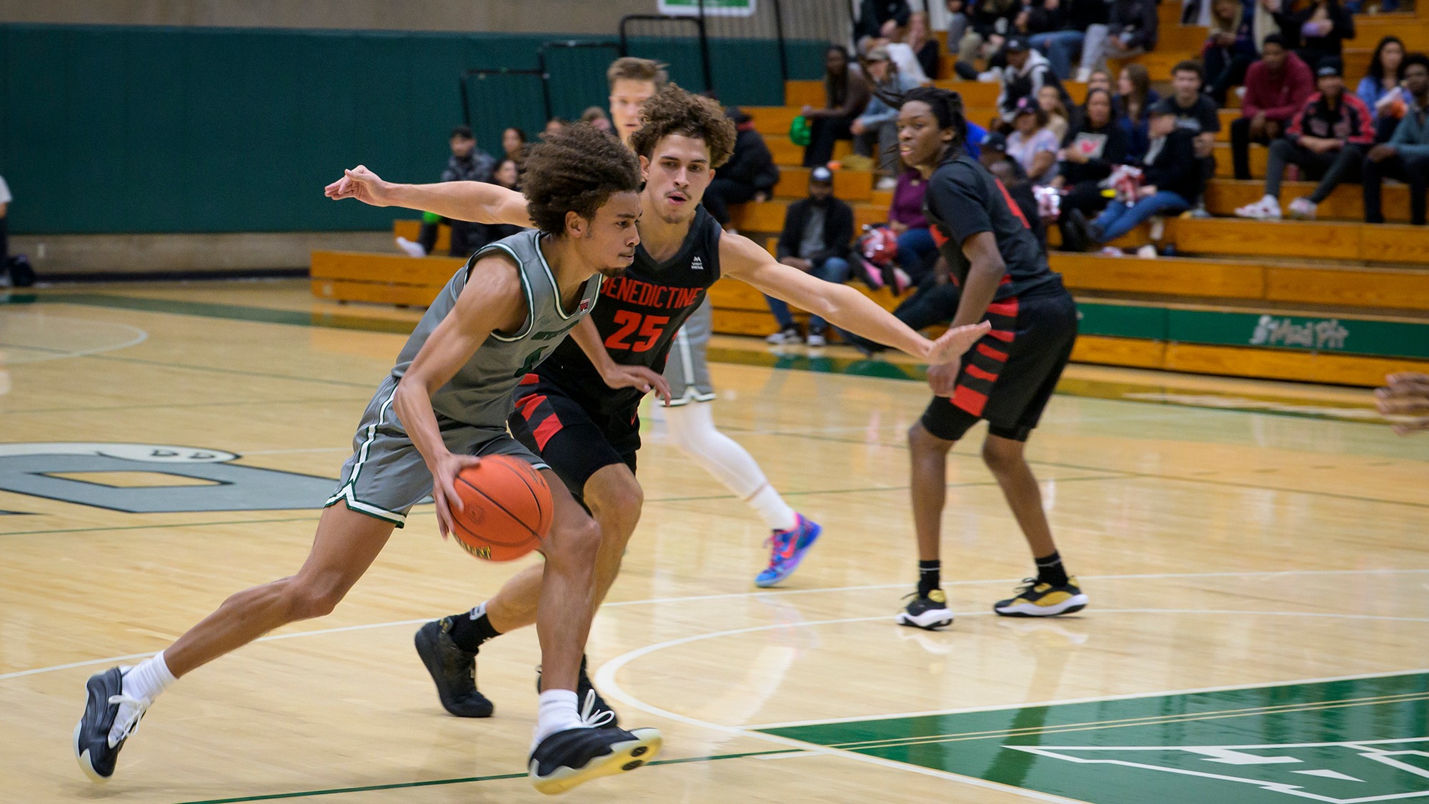 Tony Frohlich-Fair drives with the basketball for Evergreen.