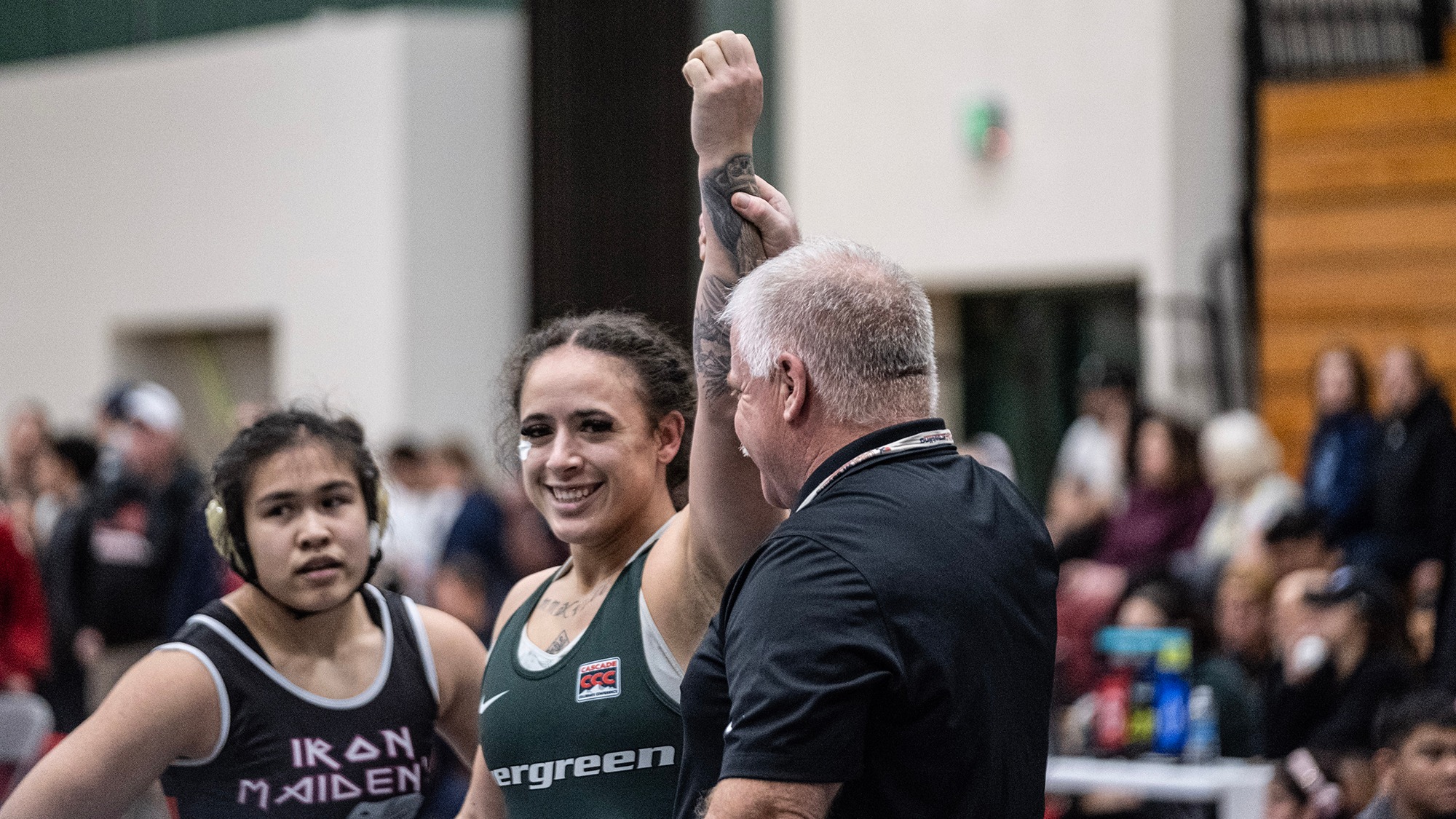 Flor Parker Borrero's arm is raised by the referee after she wins a match.
