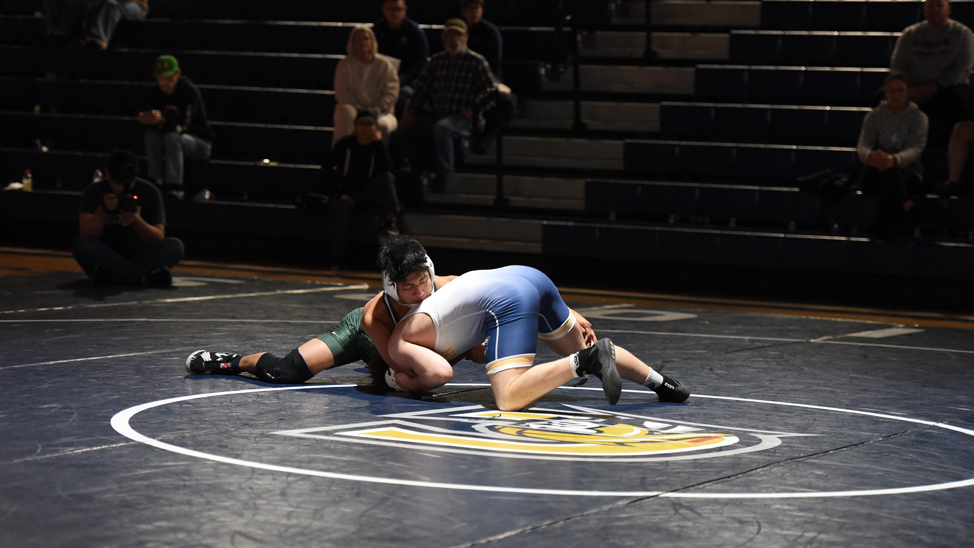 Horacio Godinez (left) wrestles for the Evergreen Geoducks.