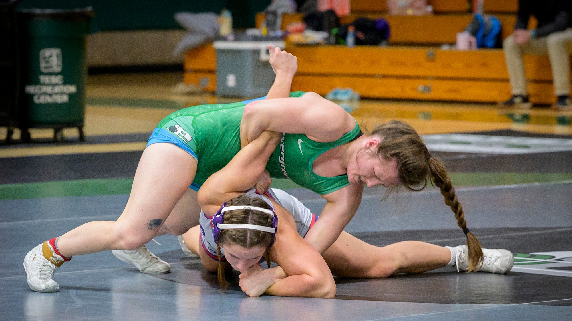 Erica Grant controls the action during a wrestling match for the Geoducks.