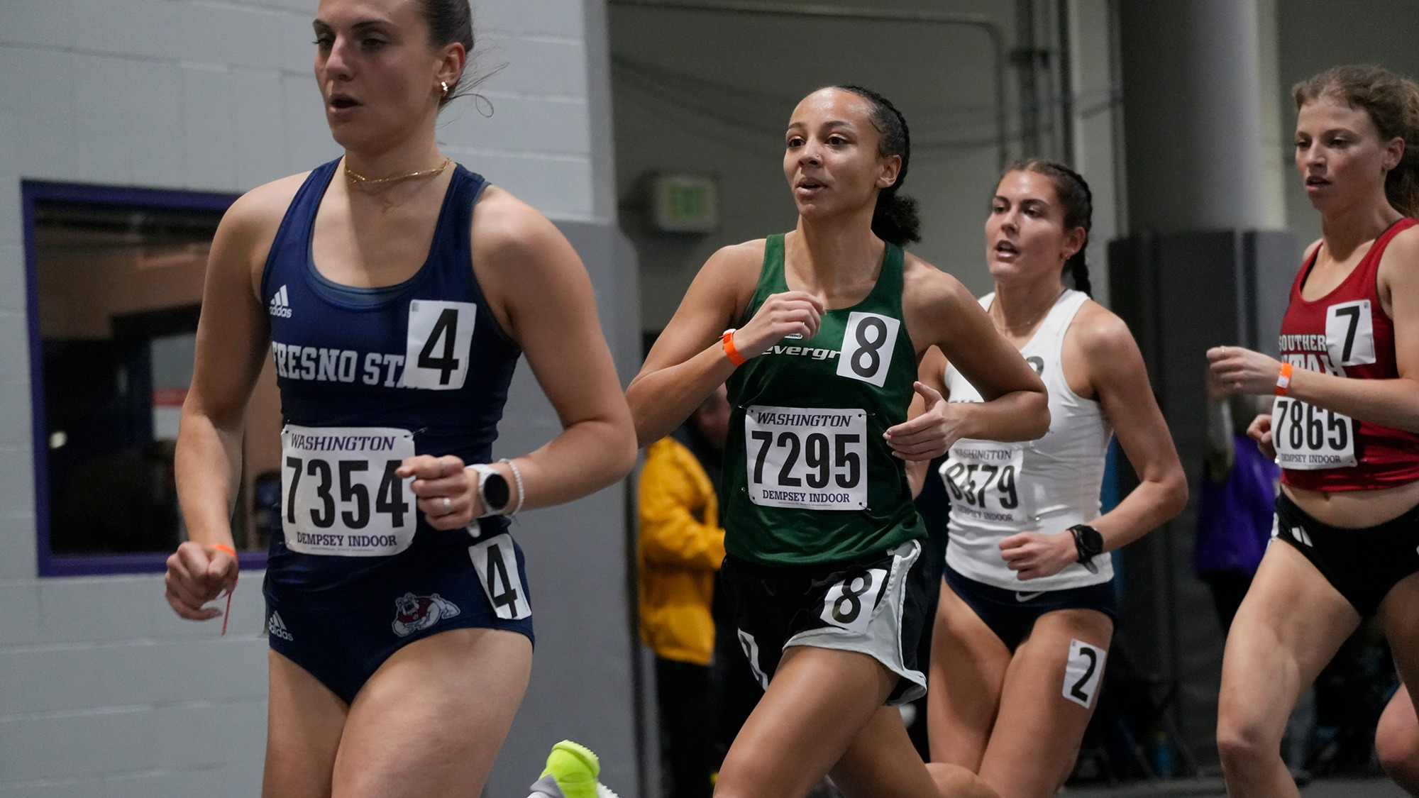 Alauna Carstens runs indoors at the UW Invite in 2026.