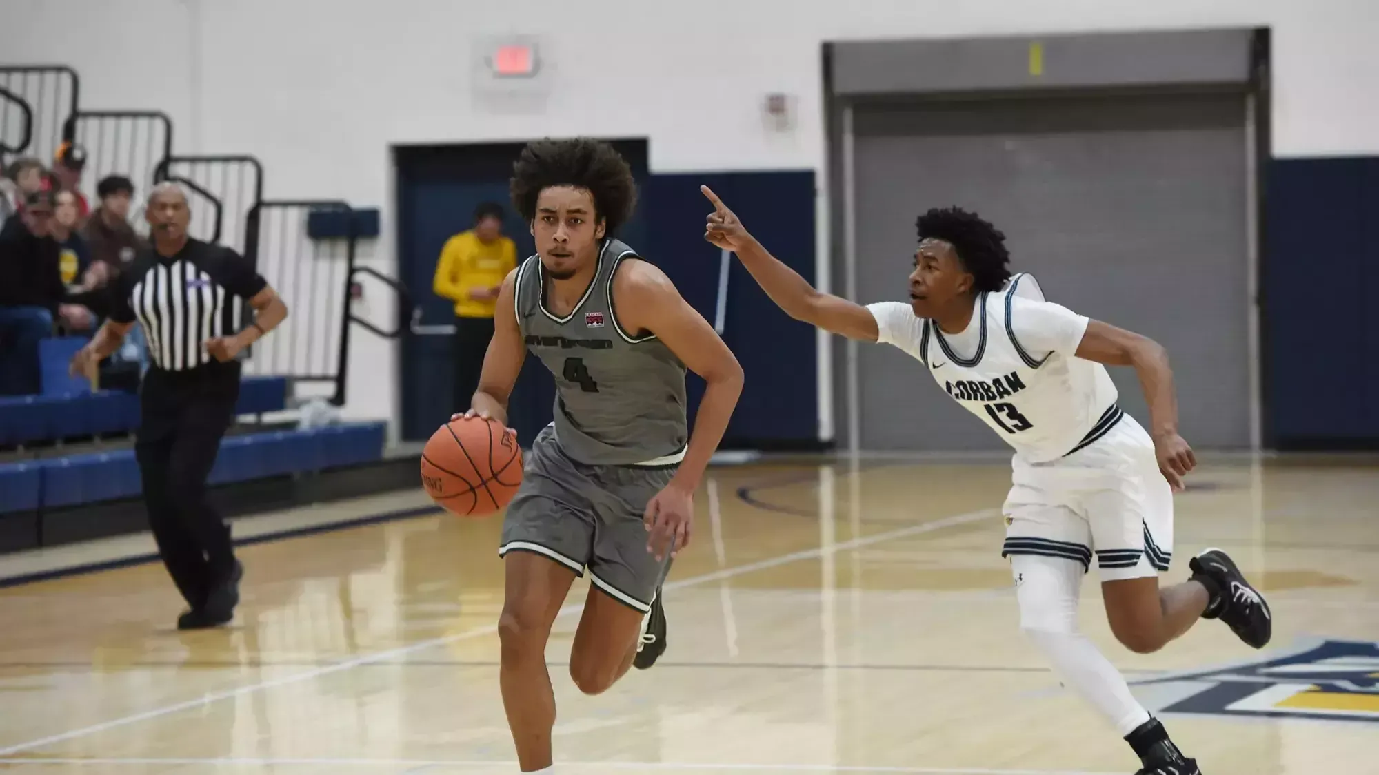 Tony Frohlich-Fair drives with the basketball for the Geoducks.