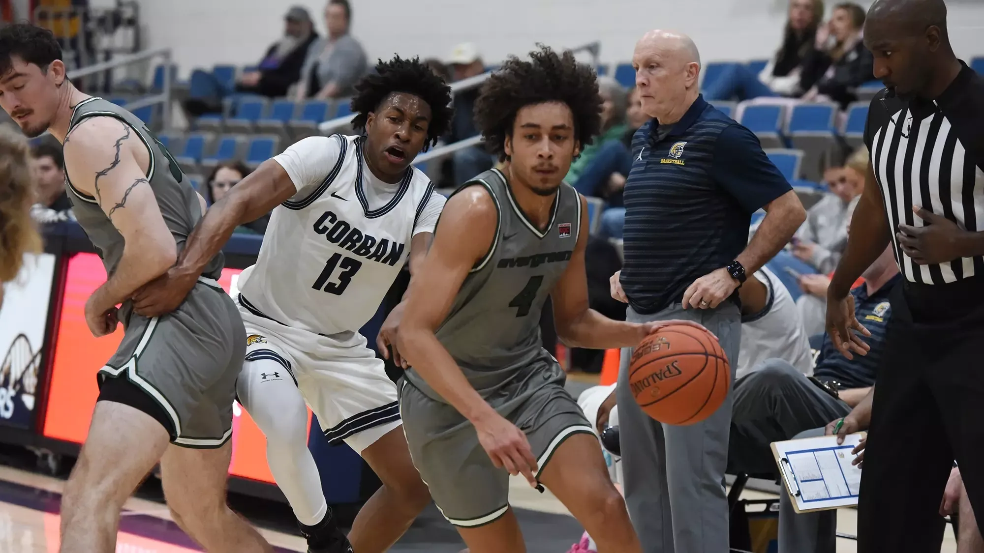 Tony Frohlich-Fair drives into the lane with the basketball.