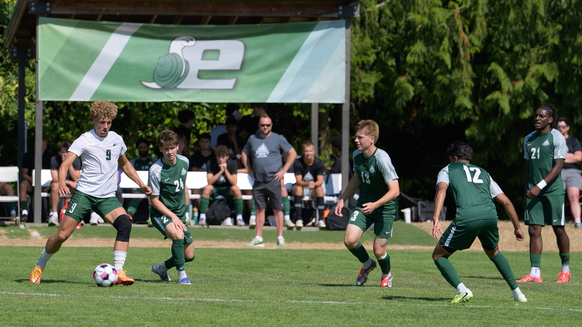 Alec Zimmeran (#9, at left) controls the ball for Evergreen.