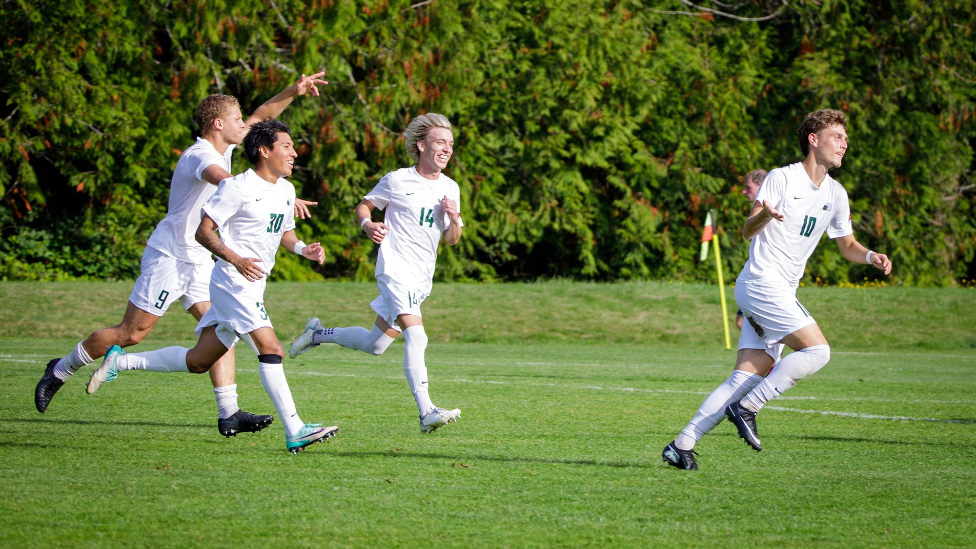 Kolby Juarez (#10, at right) and teammates celebrate a goal.