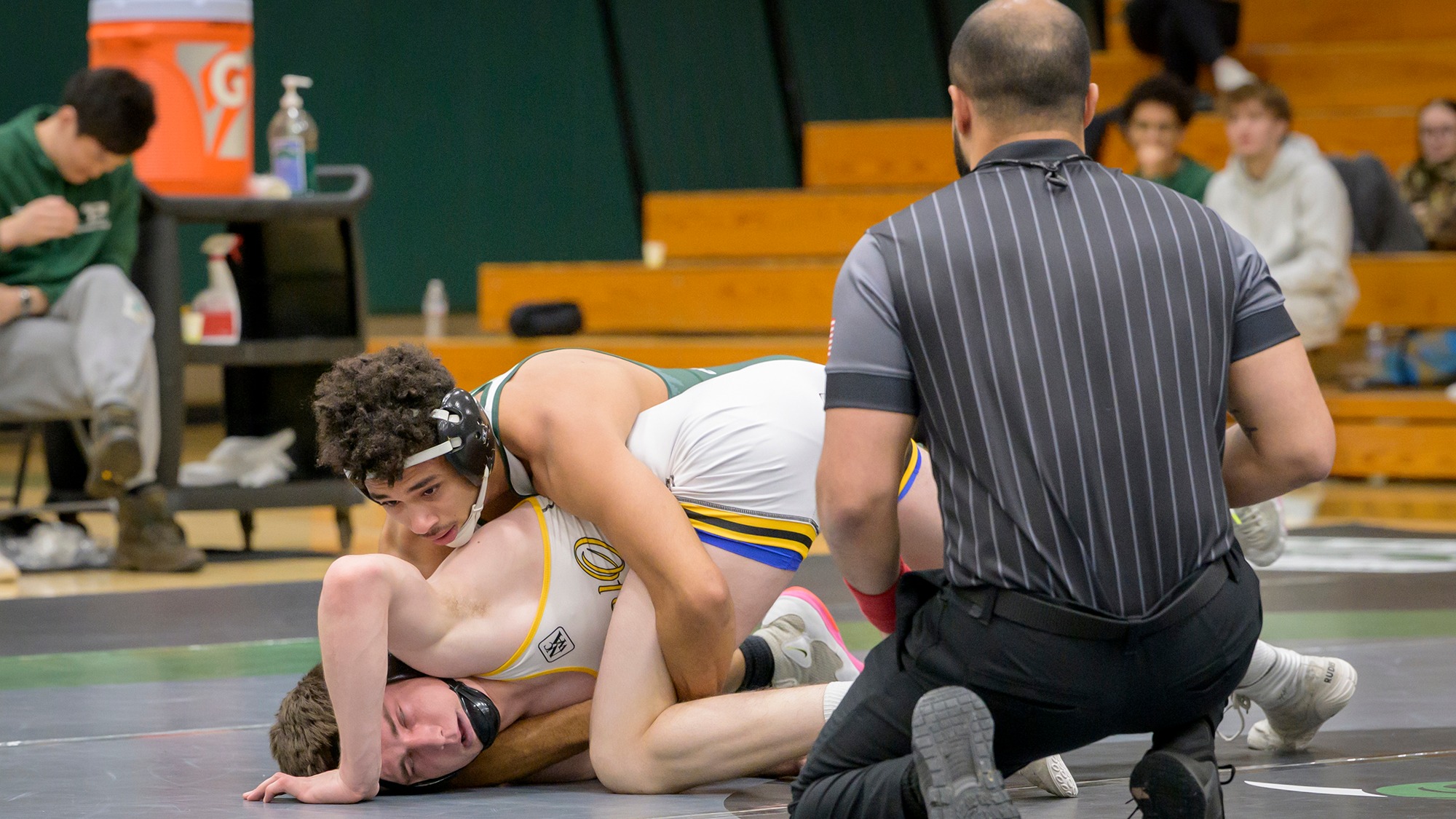 Hassan Abdi controls his opponent during a wrestling match.