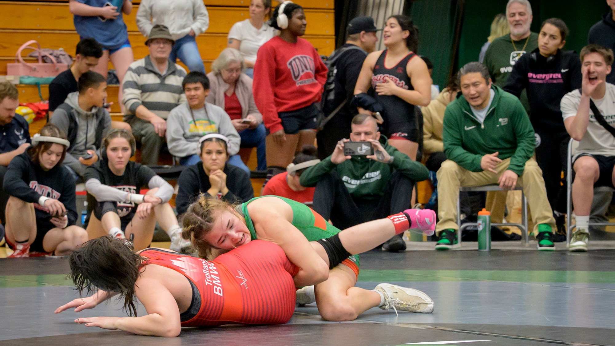 Haley Le holds an opponent's leg during a match.
