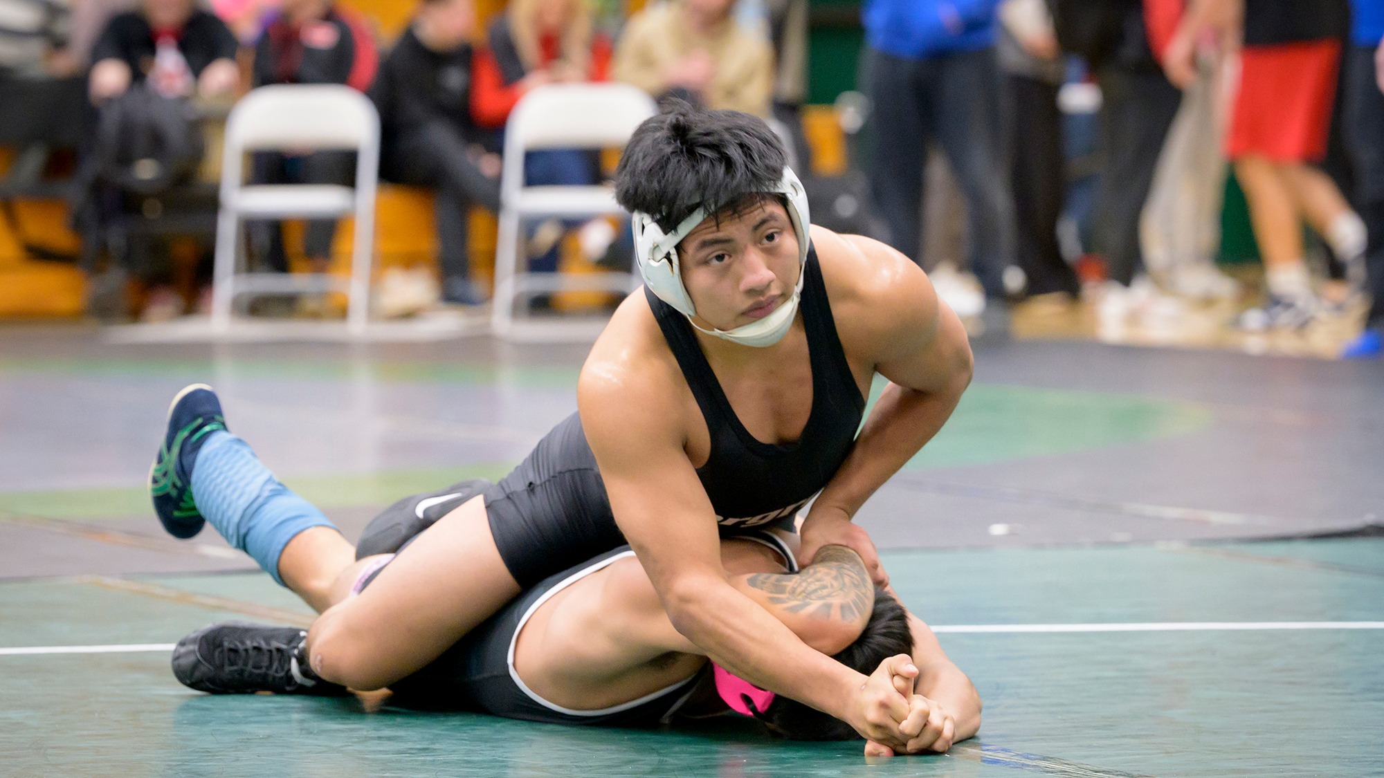 Horacio Godinez controls his opponent while wrestling.