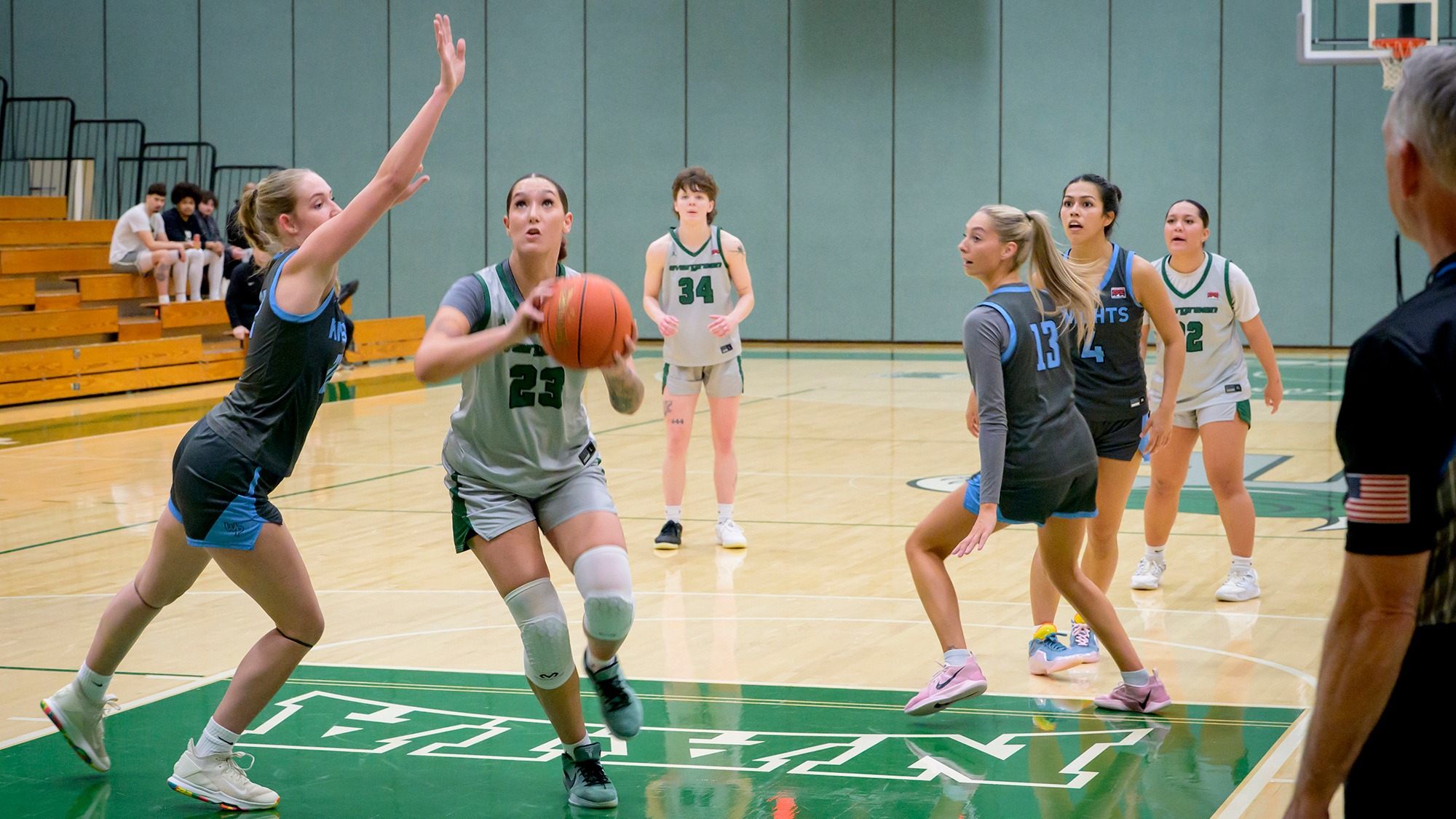 Bayleigh Harder gathers the basketball to shoot.