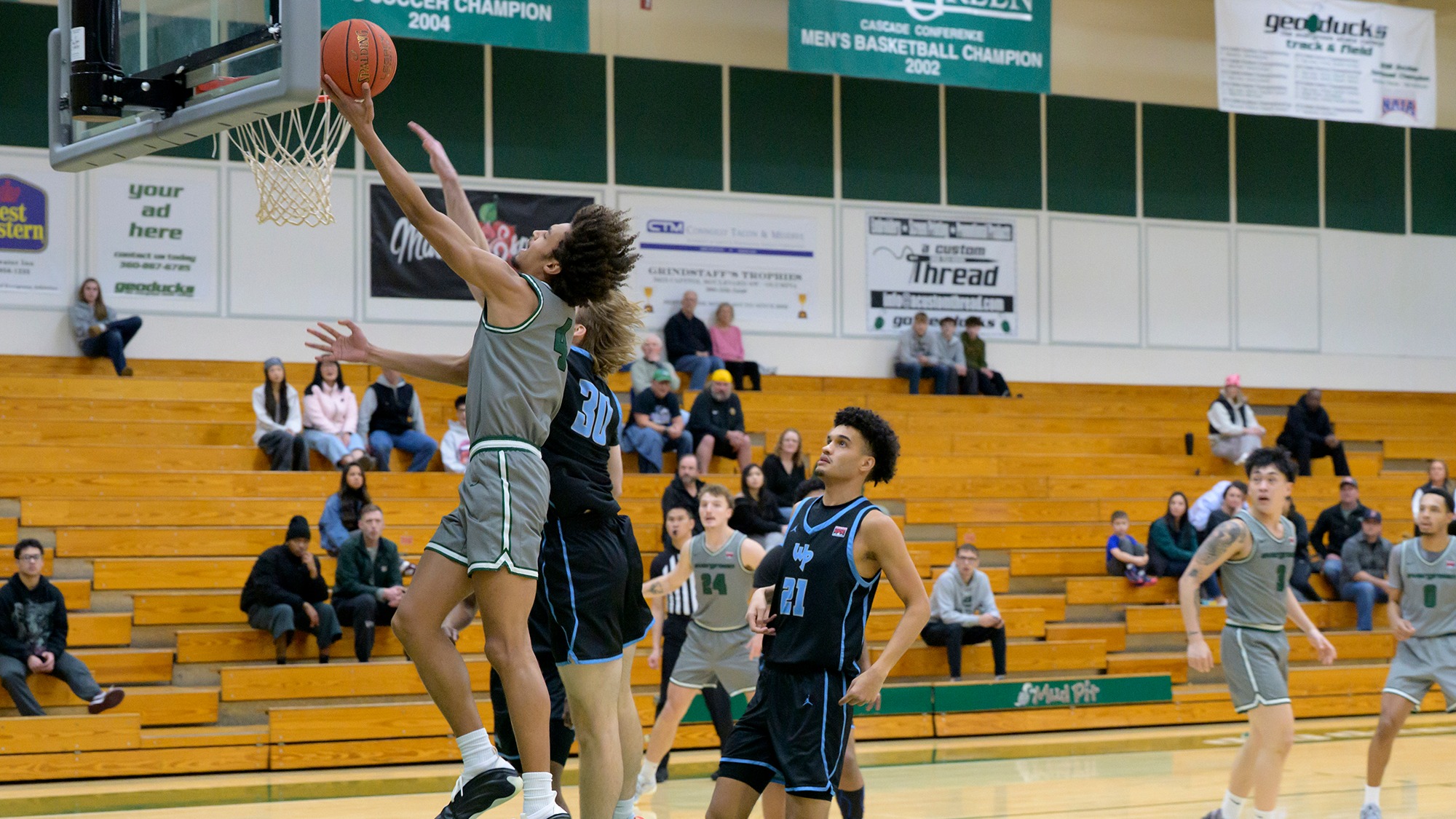 Tony Frohlich-Fair releases a layup for the Geoducks.