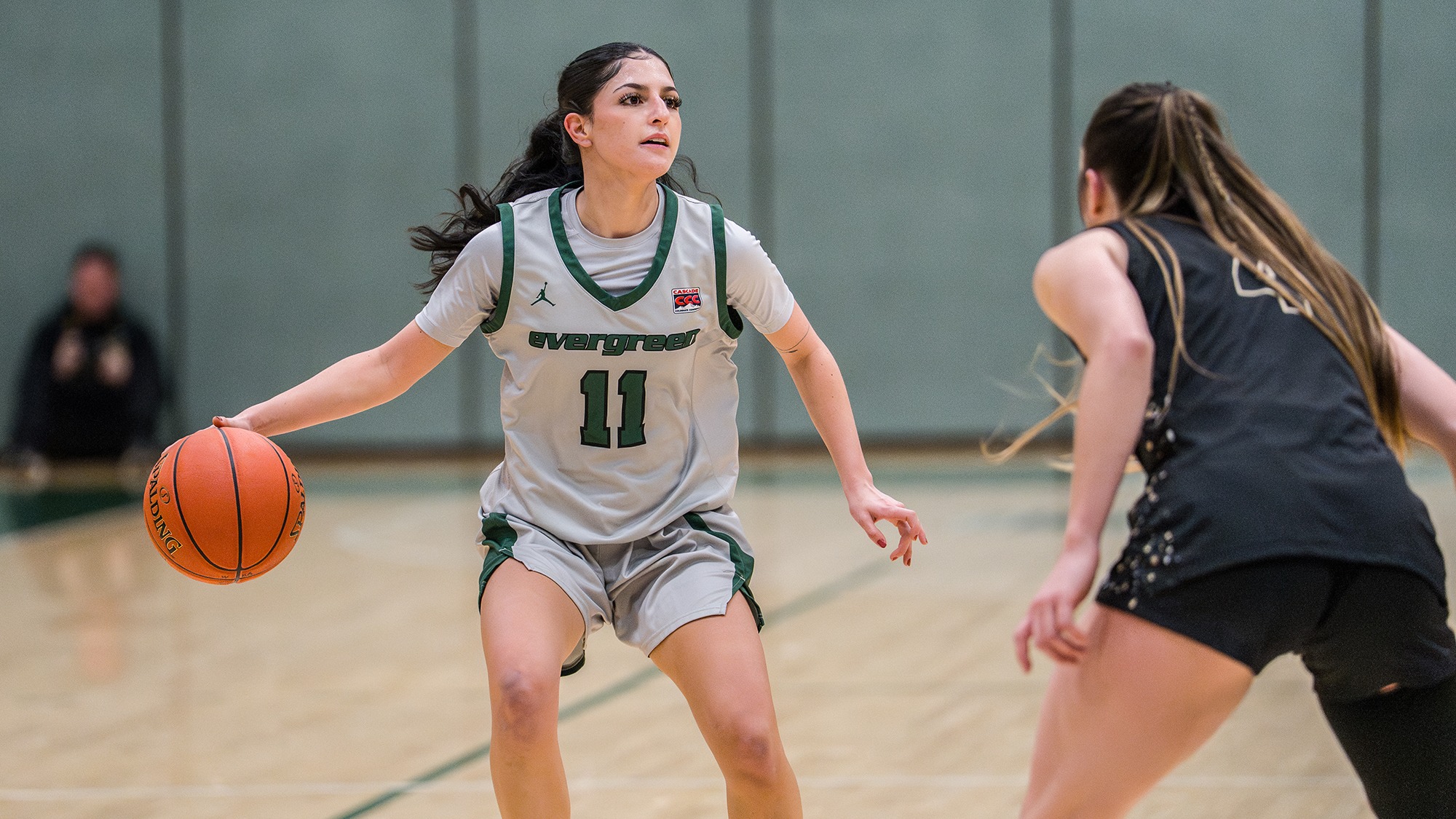 Sahara Soufi looks for options to pass while dribbling the basketball.