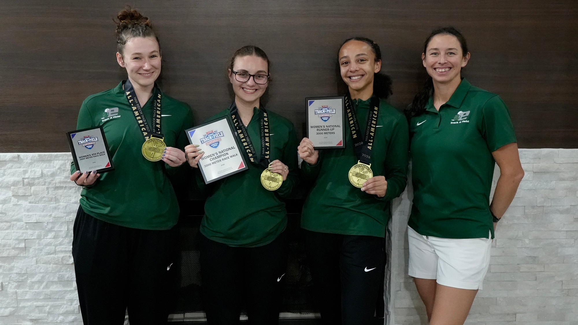Evergreen women's track and field athletes with NAIA awards (left to right):  Madison Palek, Izabelle Trefts, Alauna Carstens, and Assistant Coach Katie Burnett. 