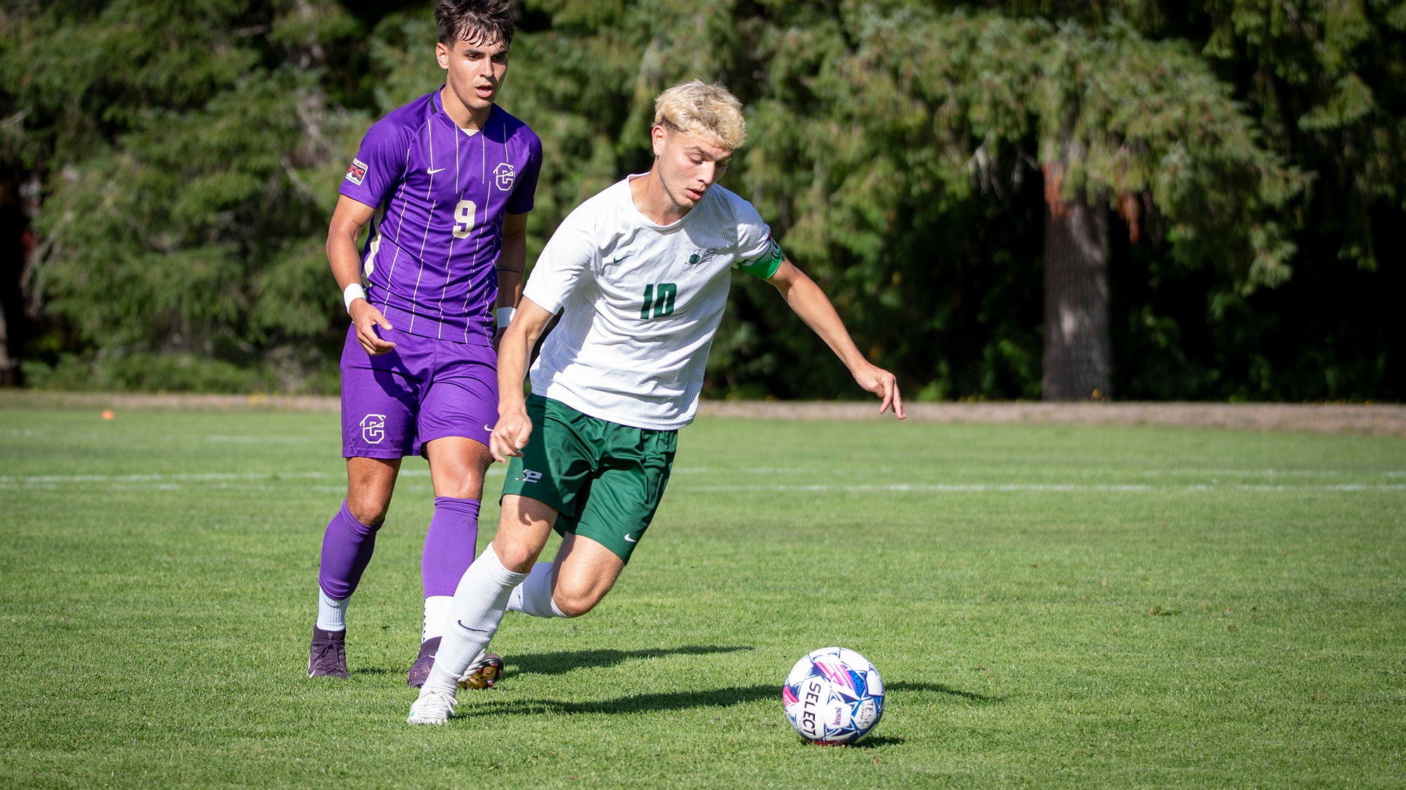Kolby Juarez controls the soccer ball for Evergreen.