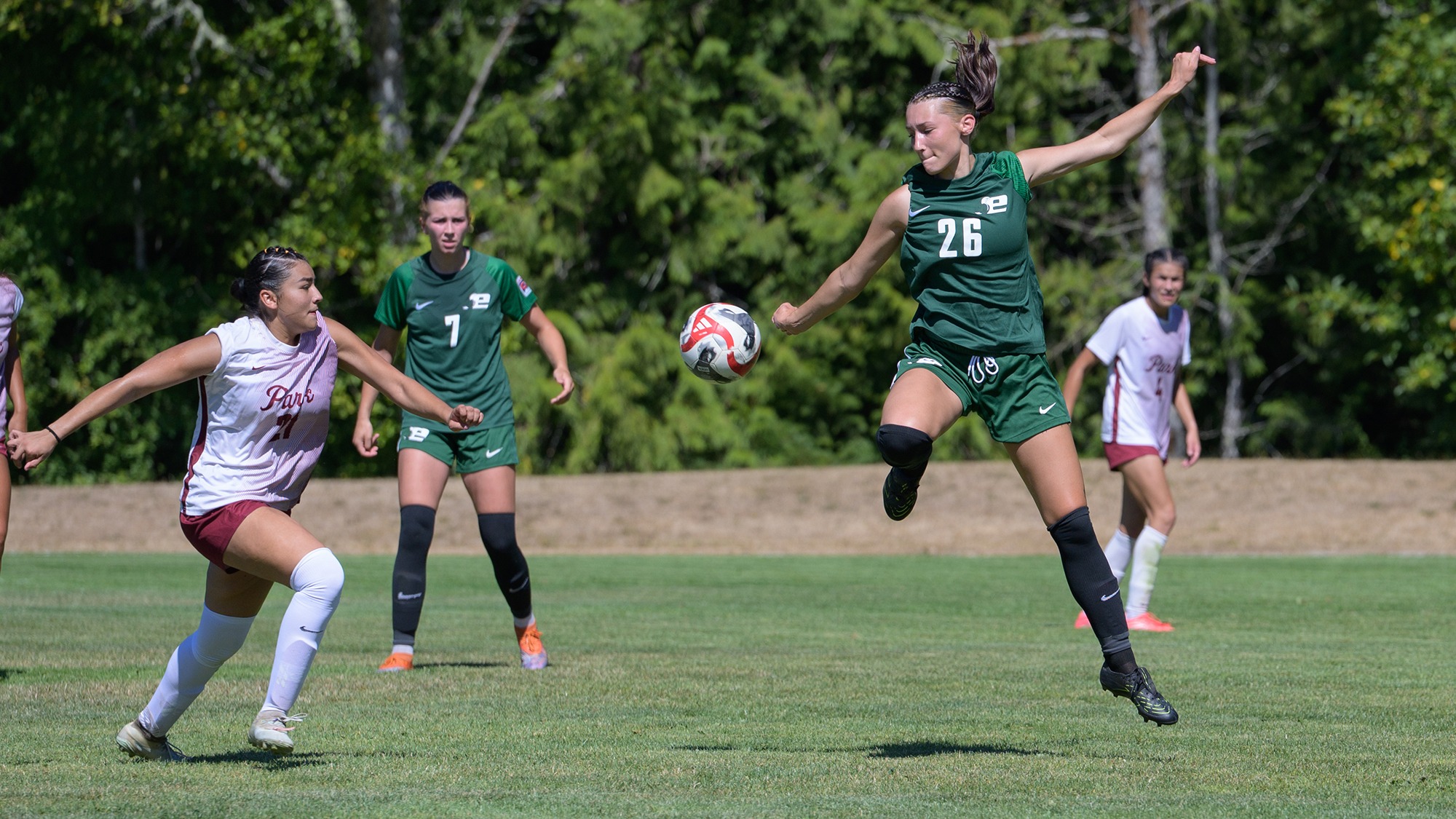 Madeline Dorendorf leaps to kick the ball for Evergreen.