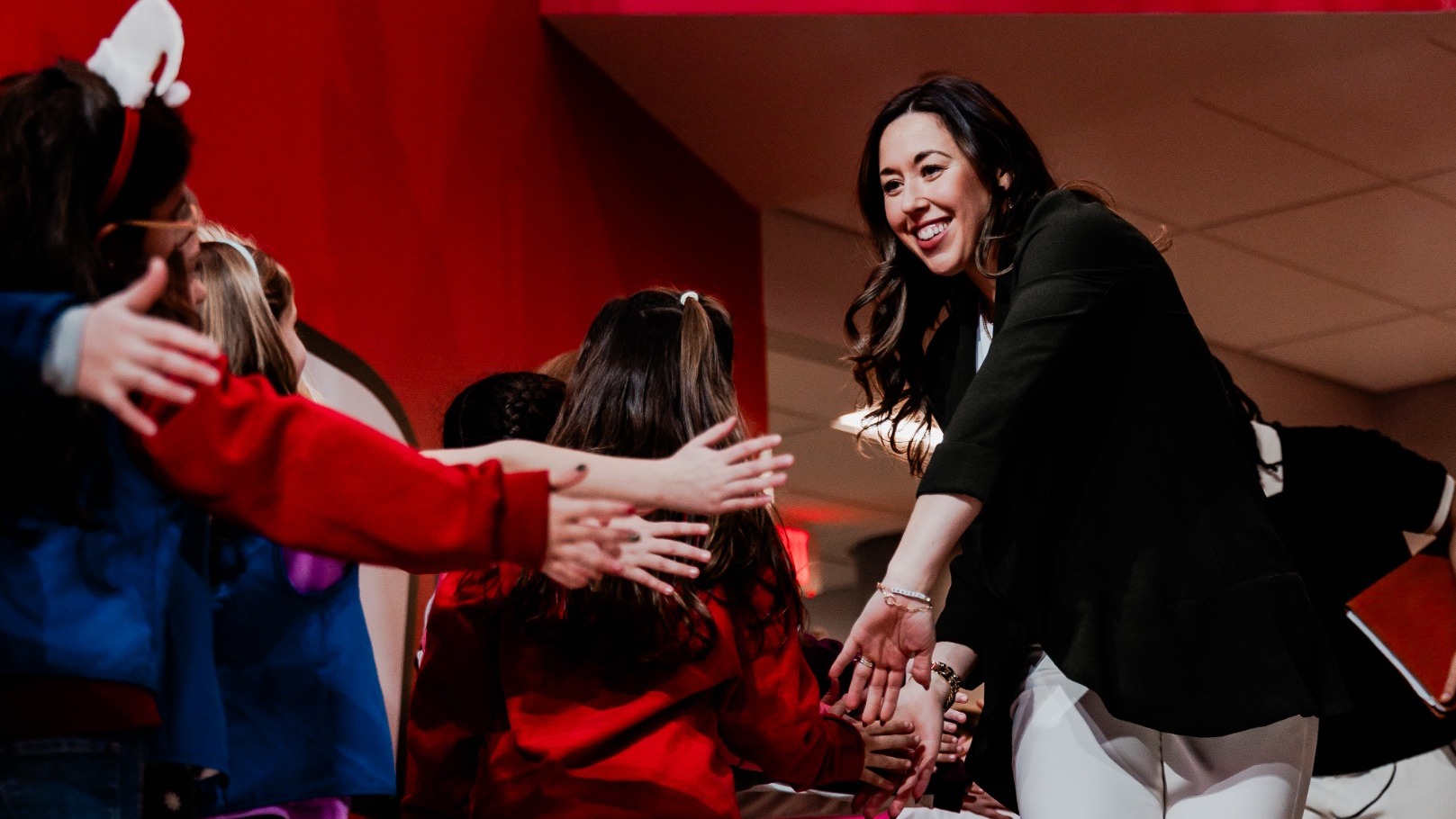 Coach Carly high-fiving fans