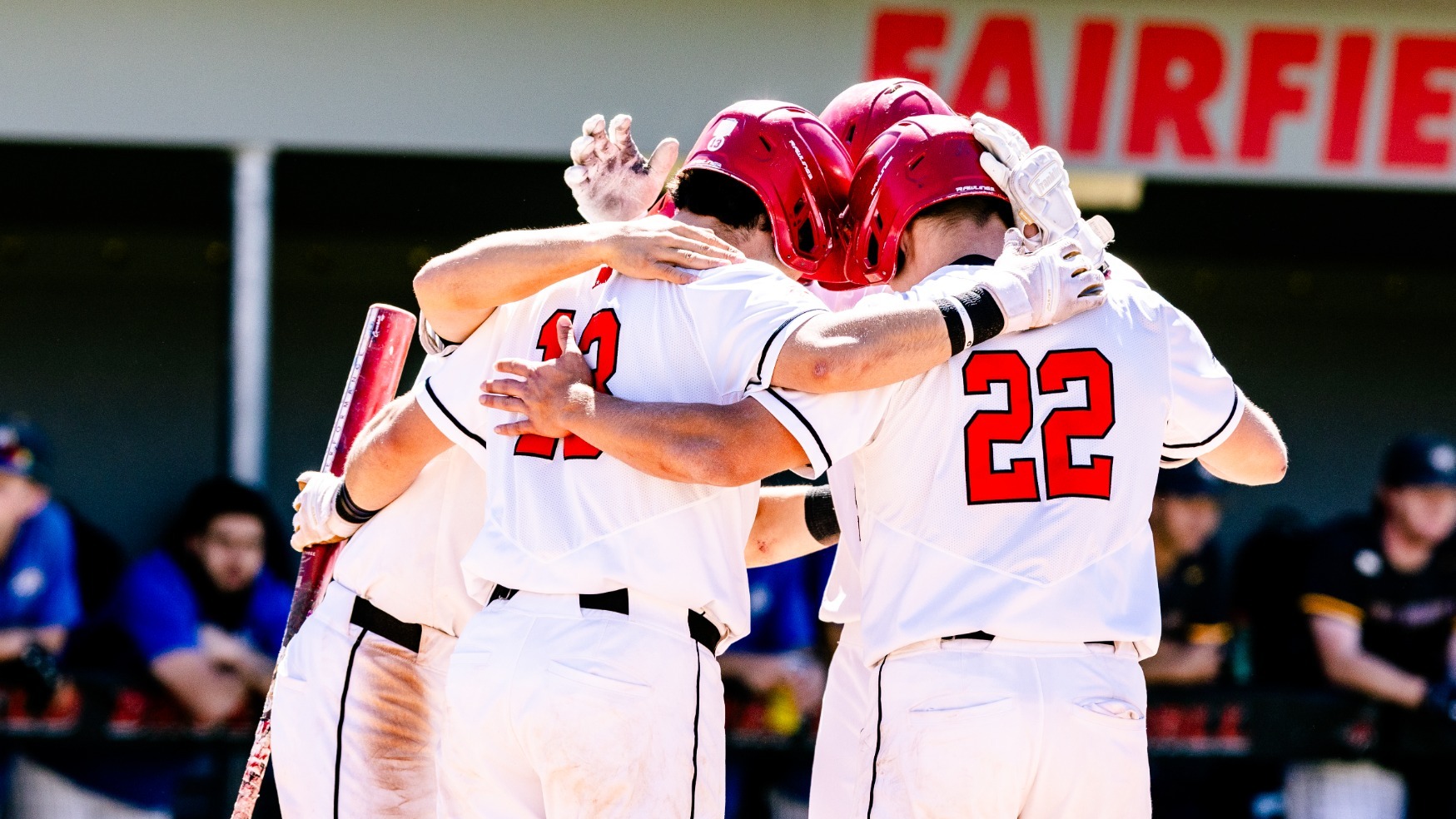 Baseball team celebrating at home after a home run