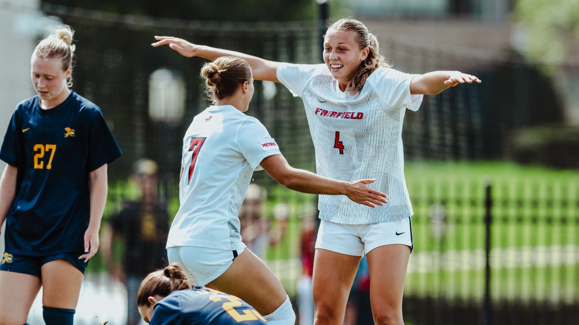 Bingham celebrates with Pisani after a goal against Canisius