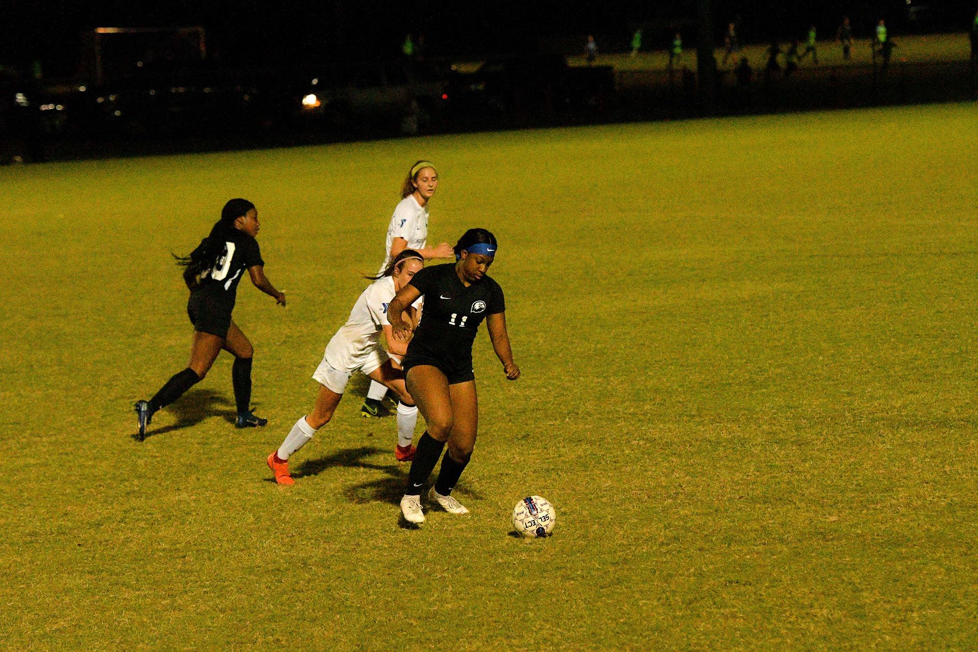 Ambrose takes on a defender