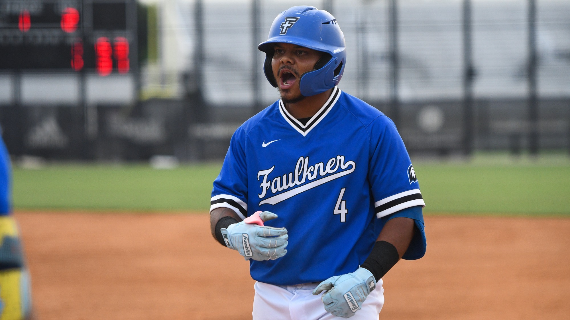 Colón celebrates his RBI single at Southeastern