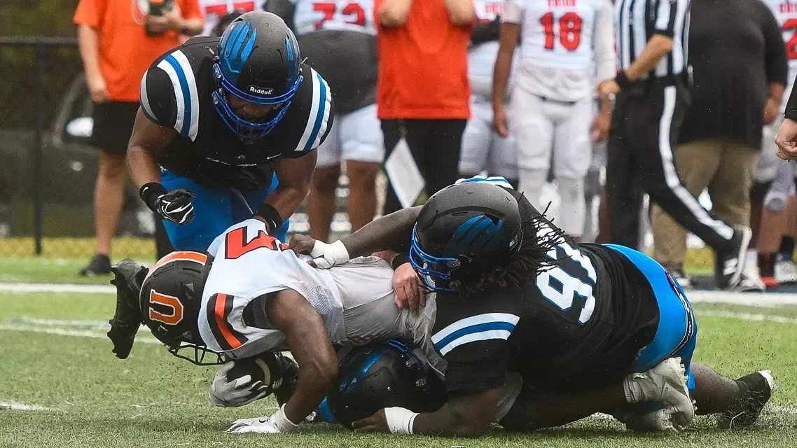 Kenorris Ford leads a backfield tackle against Union