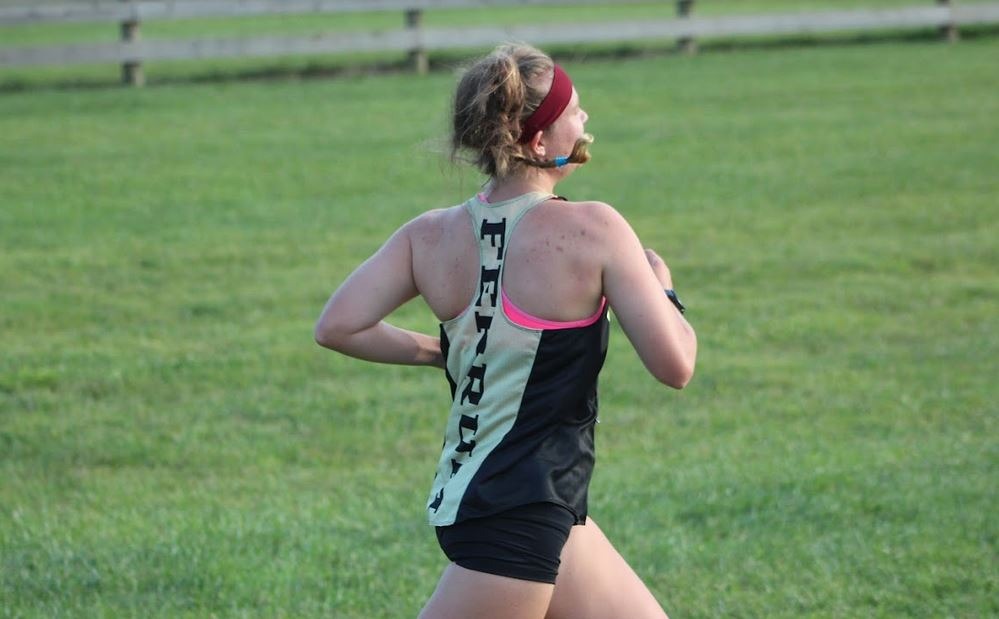 Eliza Montgomery participating in a Cross Country meet for the 2022 season. 