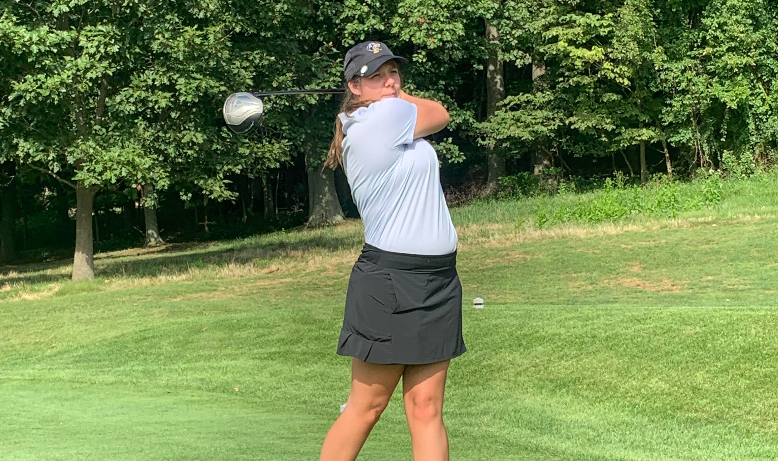 Hunter Tharpe looks at where her ball travels after teeing off
