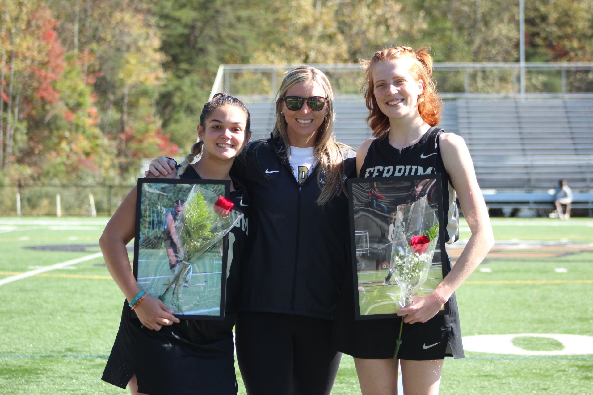 Field Hockey Seniors Rylee Smith and TJ Baker pictured with Coach on Senior Day 2023.