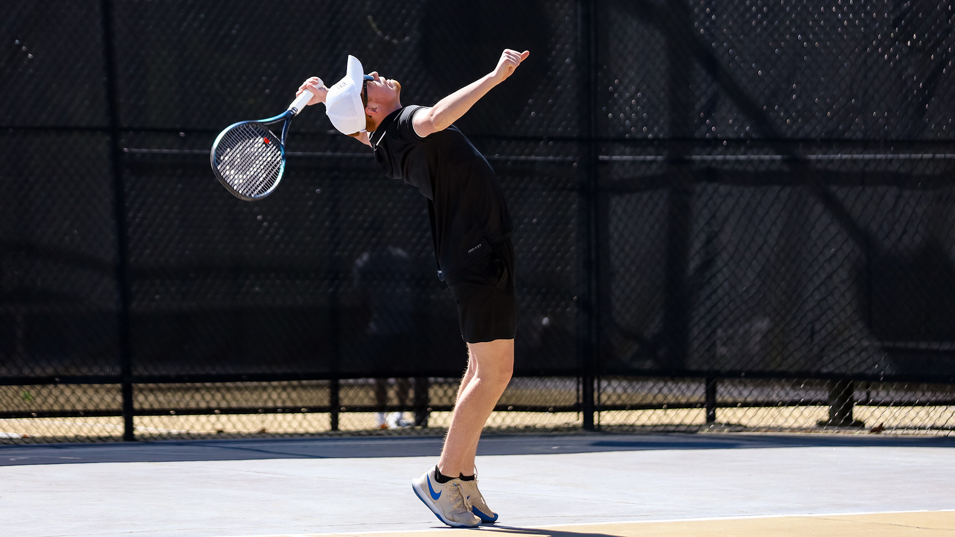 Freshman Austin Brigman with a big serve in Ferrum's home match against Mary Baldwin April 7, 2024.