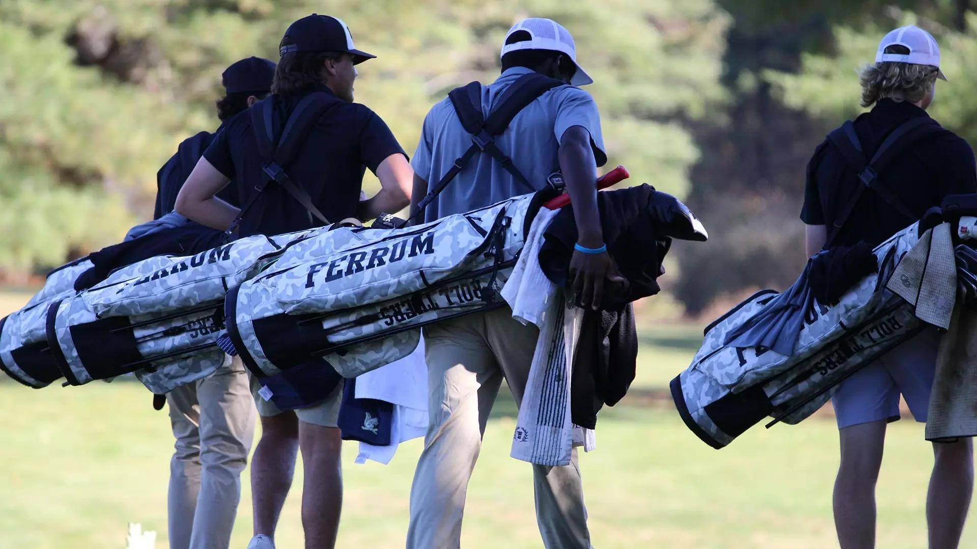 Four Ferrum men's golfers head down the fairway after teeing off in October 2025.