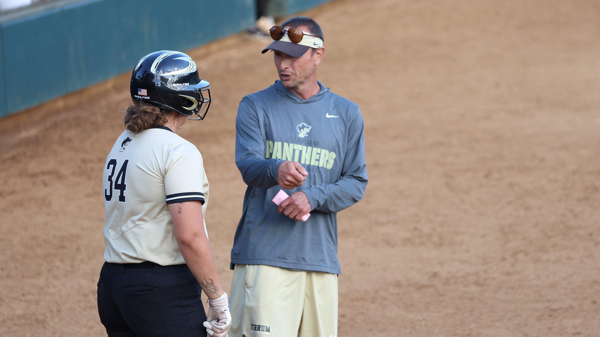 Ferrum Head Softball Coach Josh Freeman talks strategy with a player during the 2025 season. 