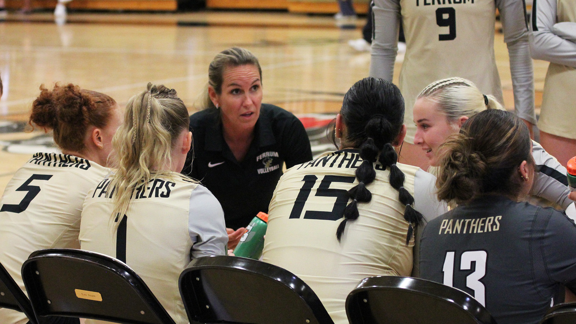 Coach Shelbylynn Adair on the bench during a timeout in a home match on September 25, 2025.
