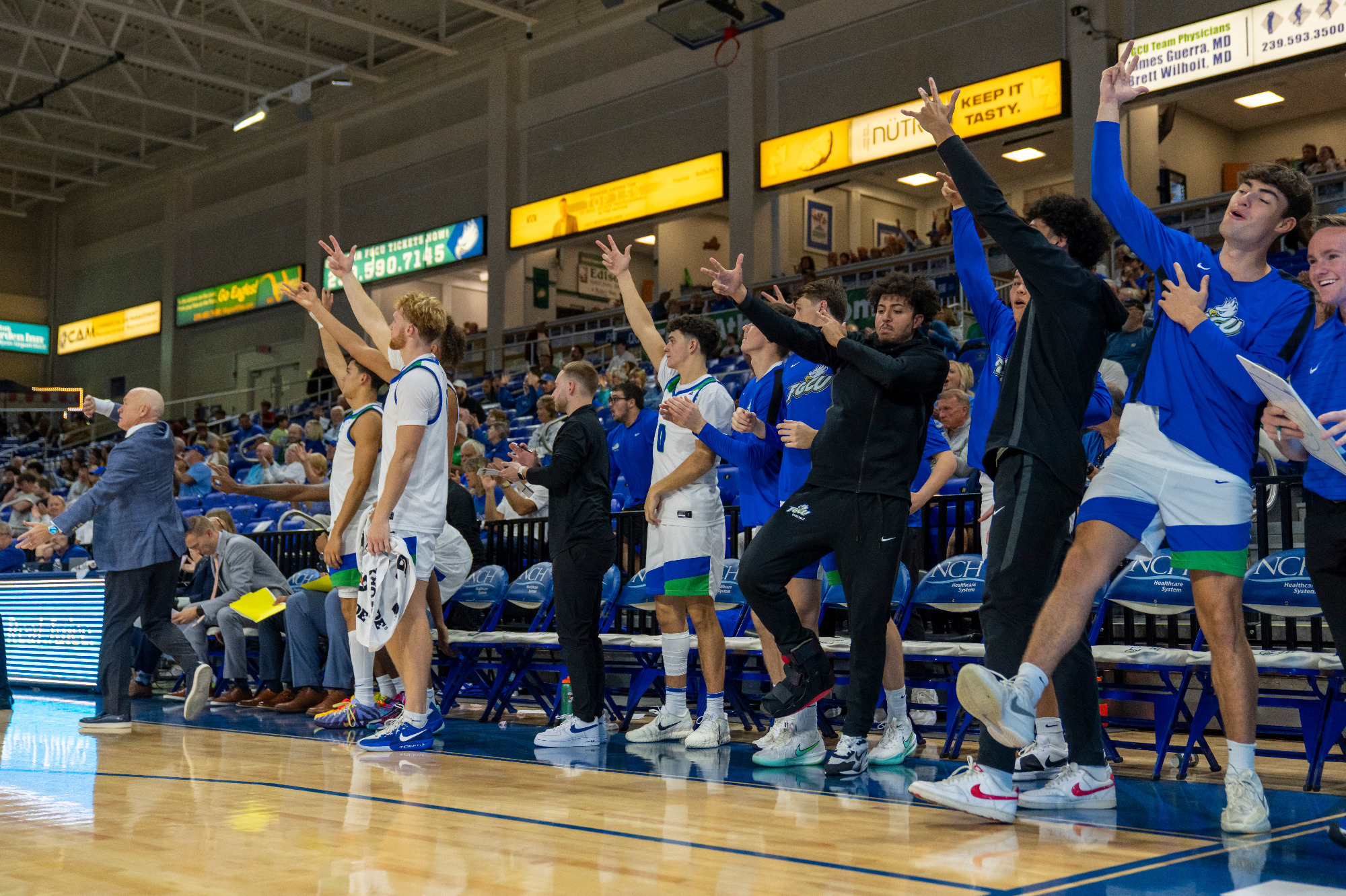 The FGCU bench celebrates after a made 3-pointer against Chattanooga.
