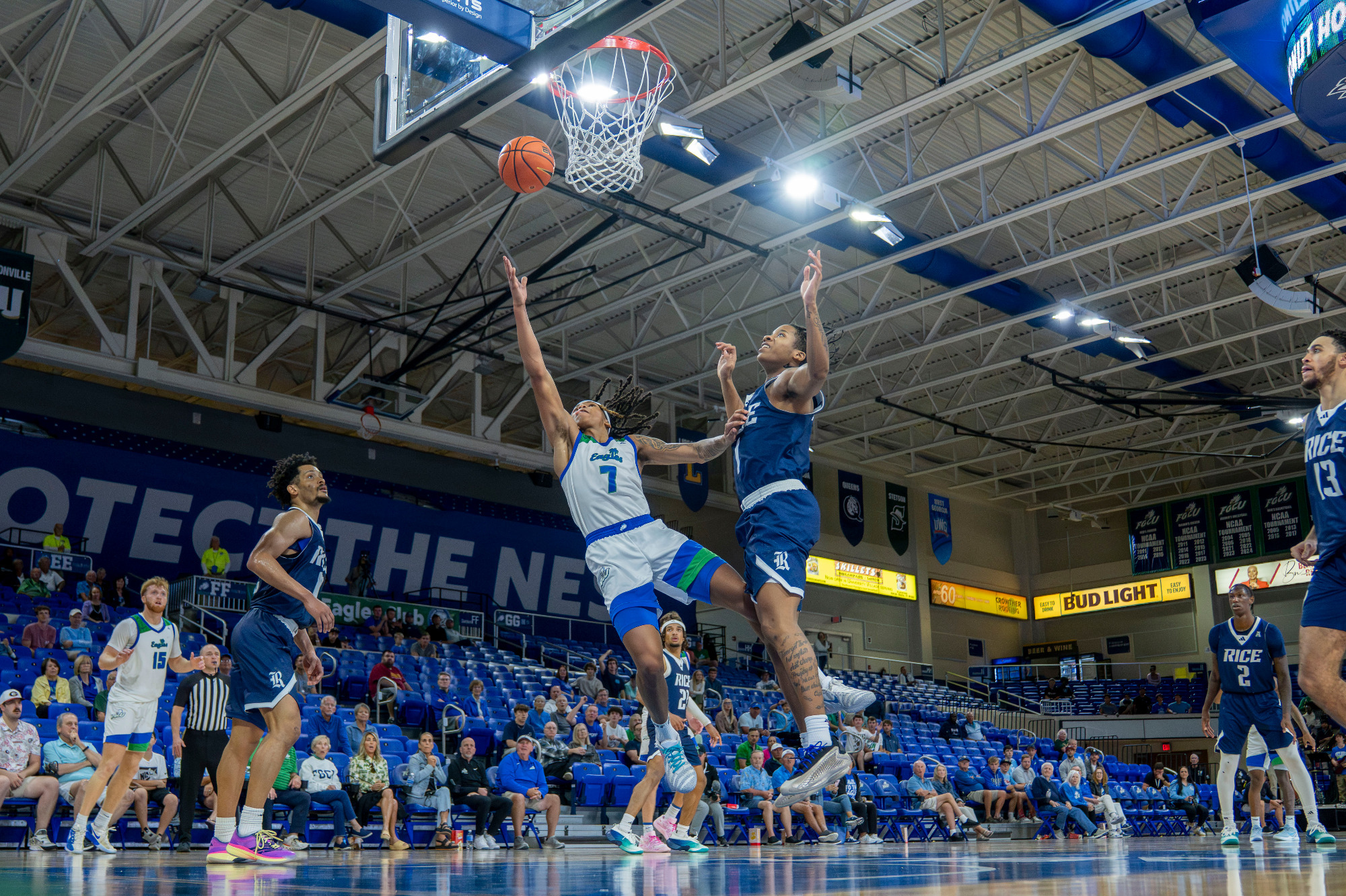 Jordan Ellerbee falls to the court as he makes a layup against Rice