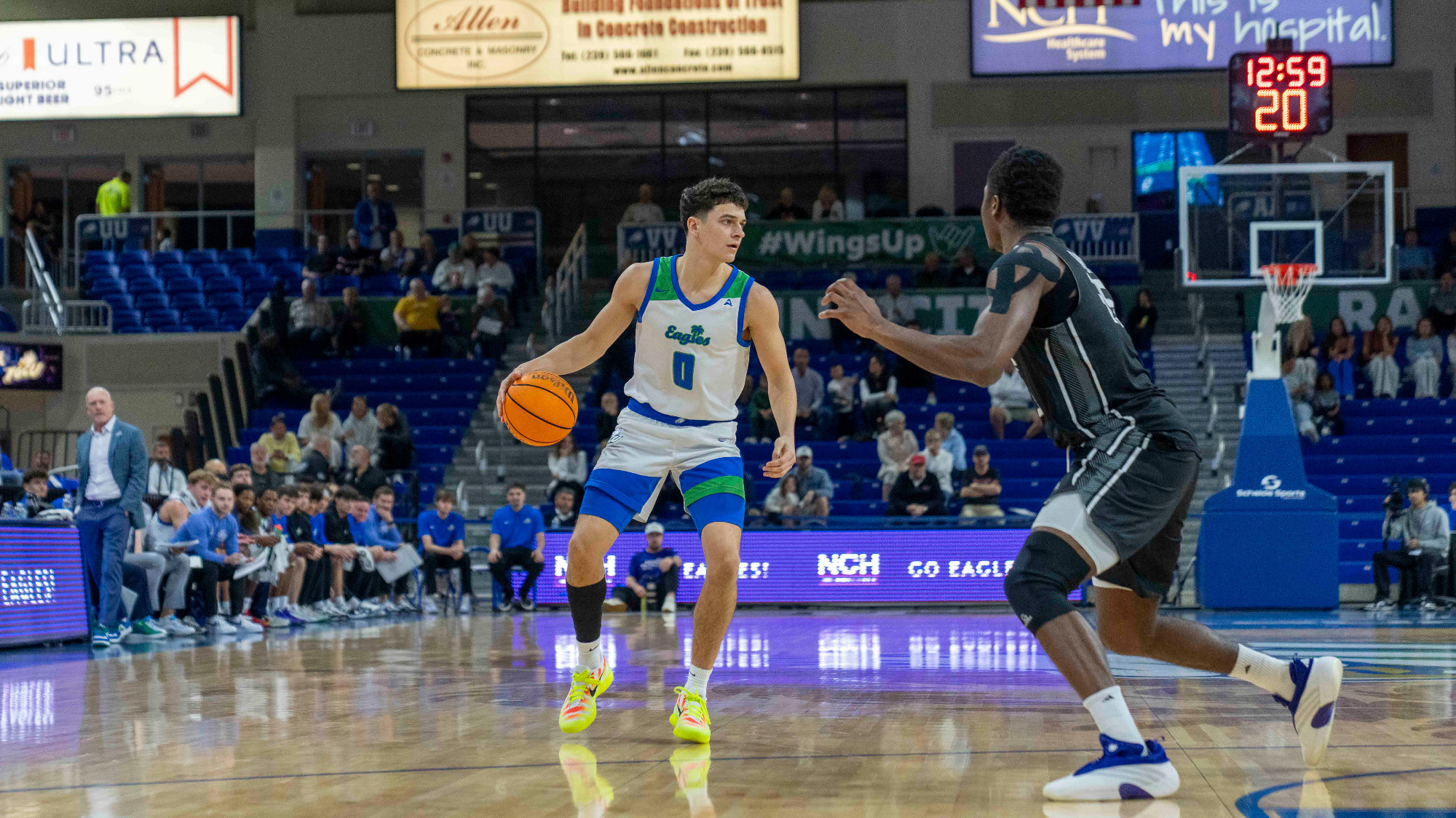 Jack Reddick dribbles the basketball against North Alabama