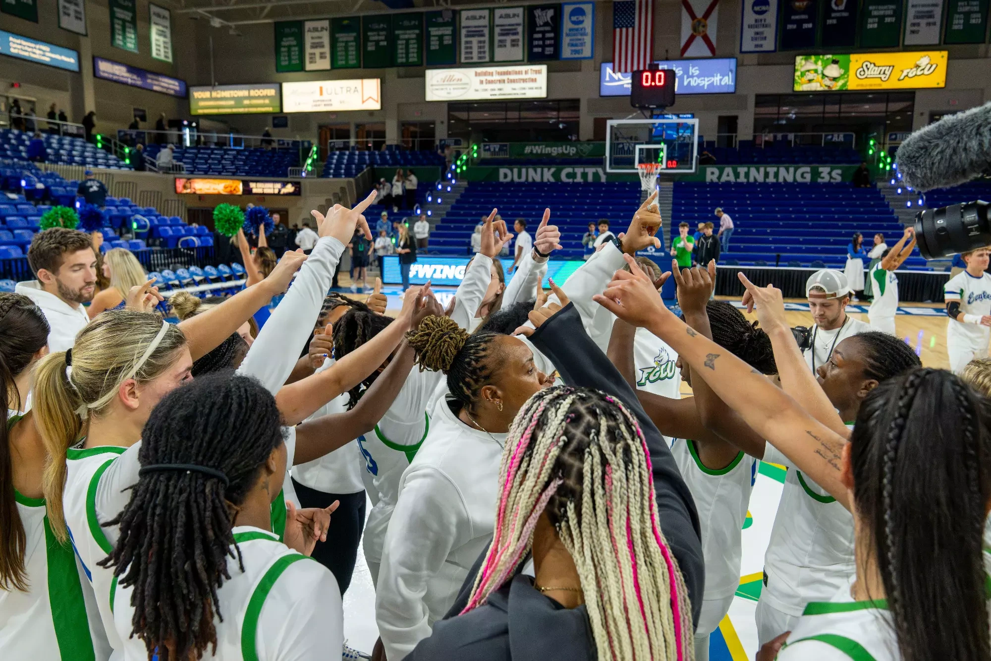 Head coach Raina Harmon huddles with her team before a game