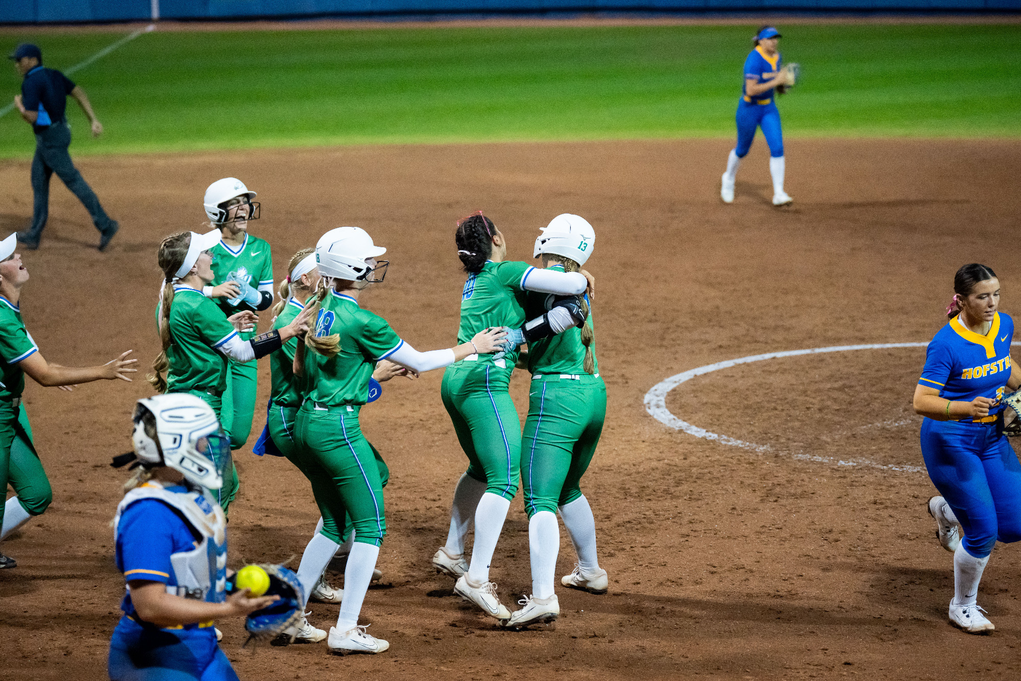 FGCU Softball rushes to hug Mackenzie Leiti after her walk-off single to beat Hofstra